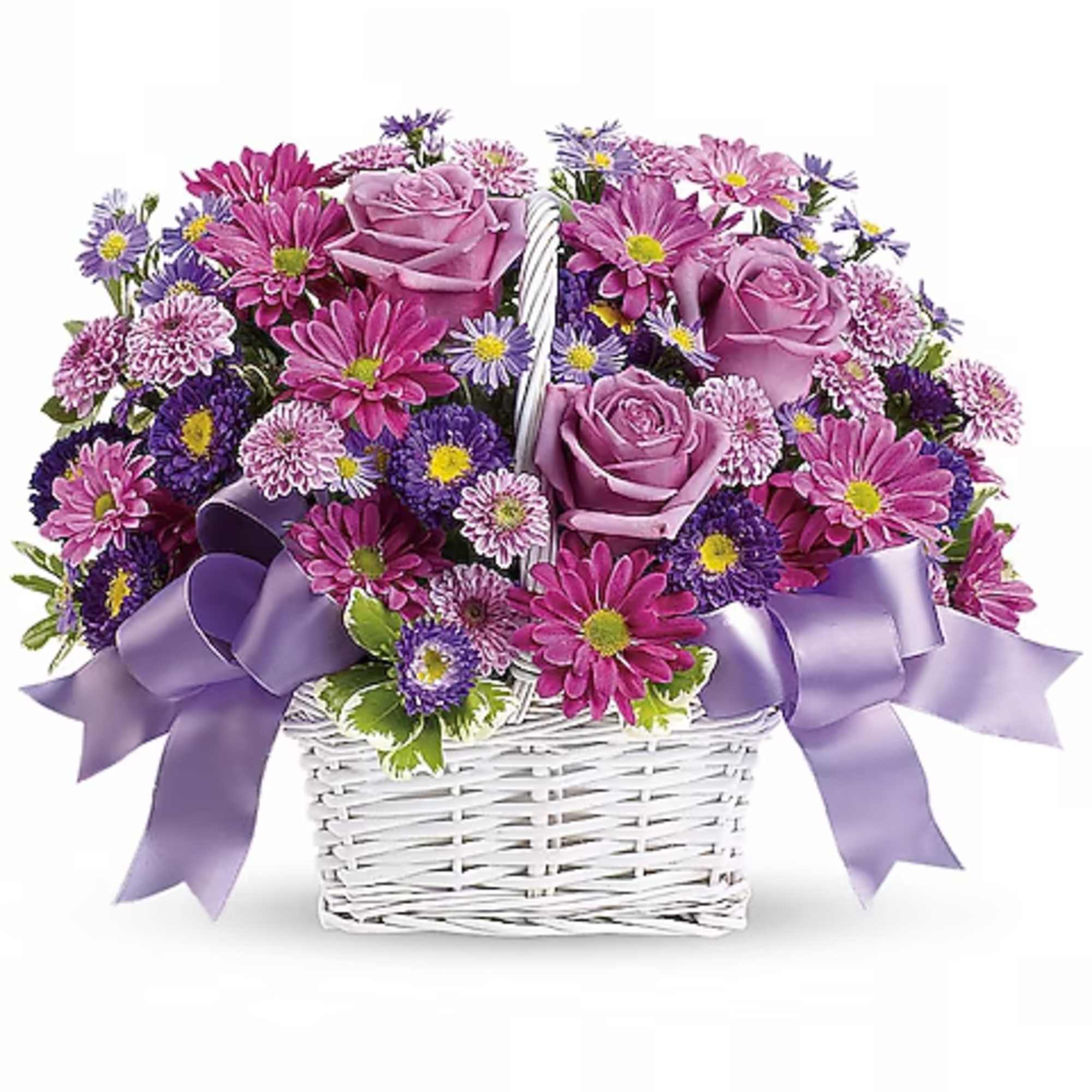 Pink and purple flowers in a white wicker basket with lavender bows
