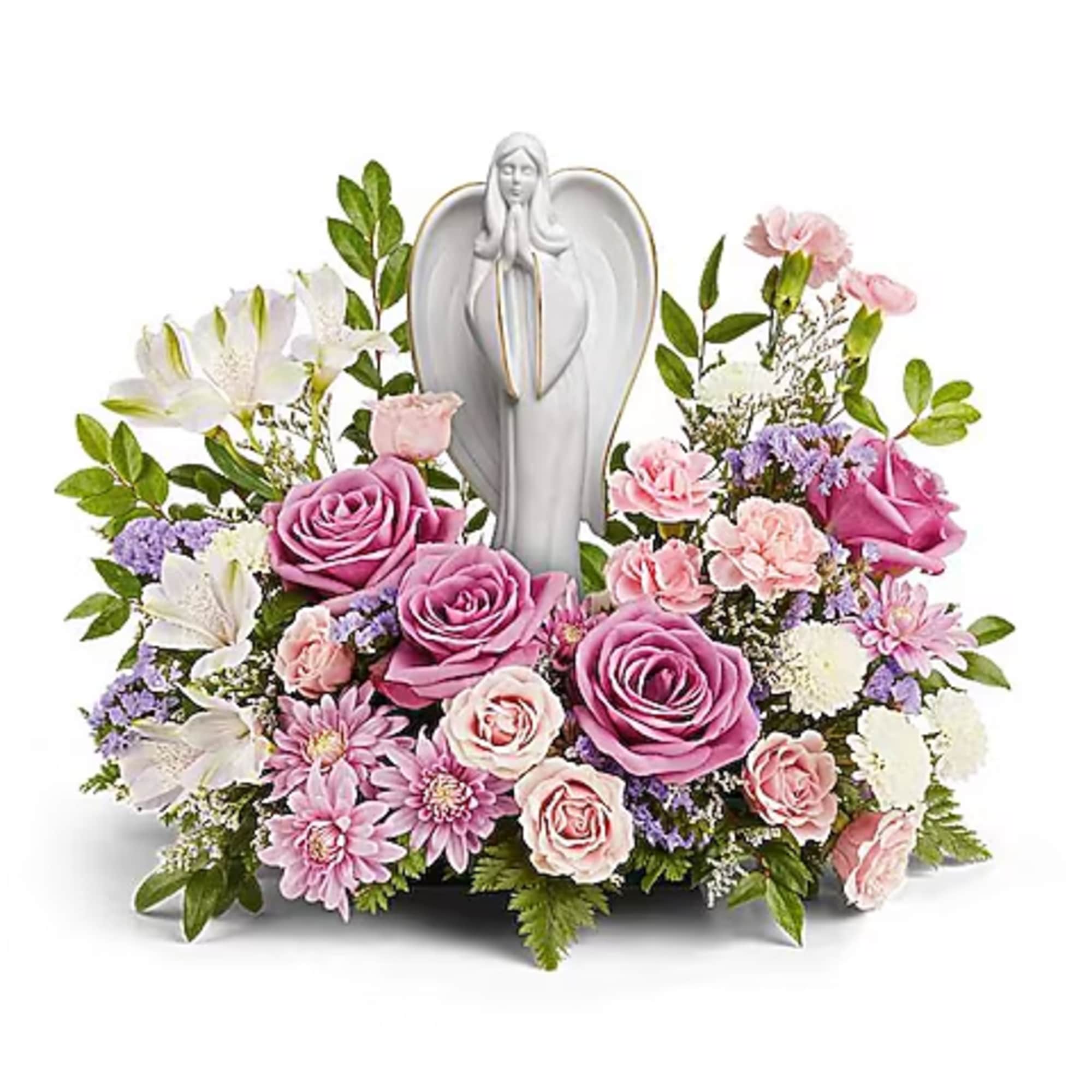 Pink and white floral arrangement with a praying angel statue centerpiece