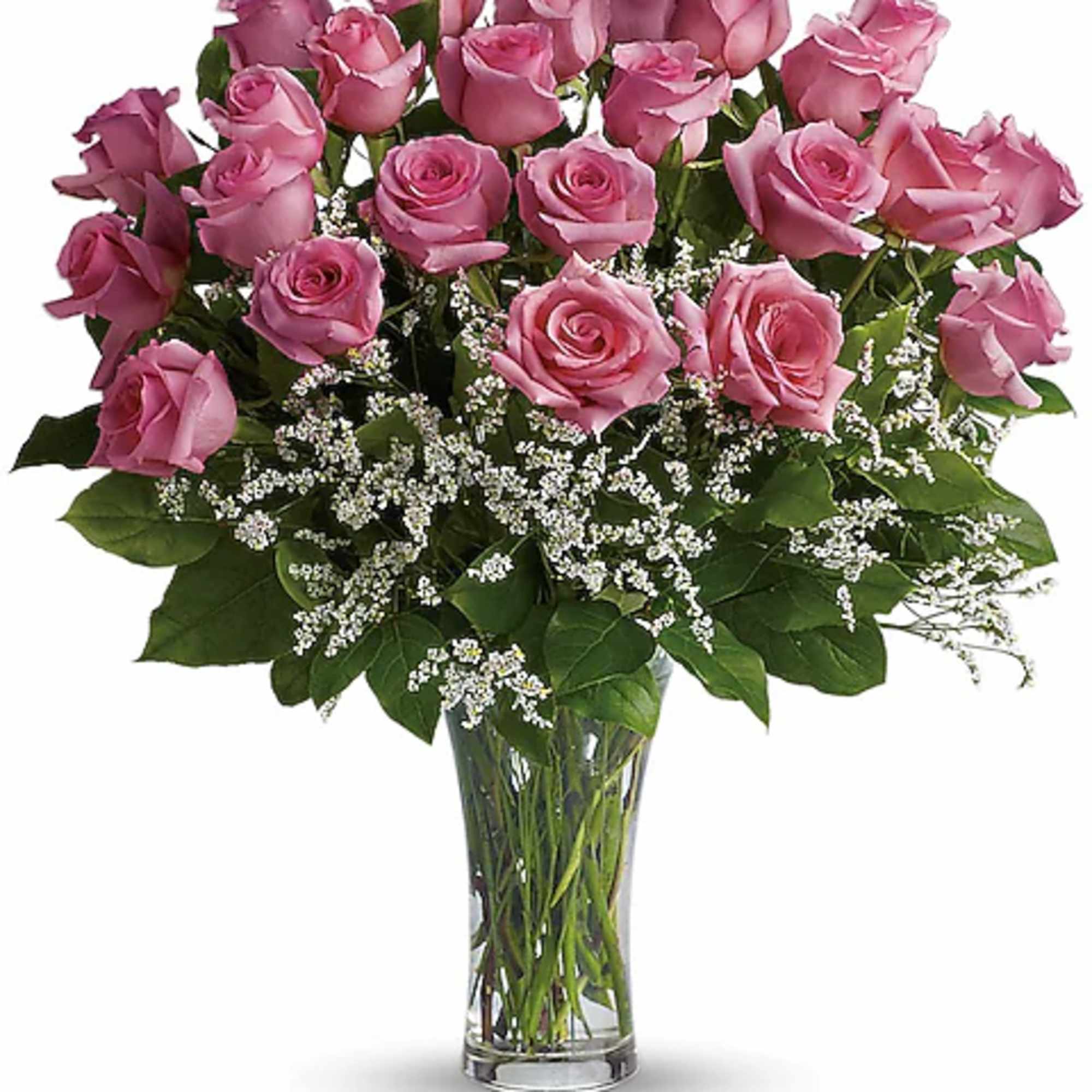 Pink roses arranged in a clear glass vase with white filler flowers