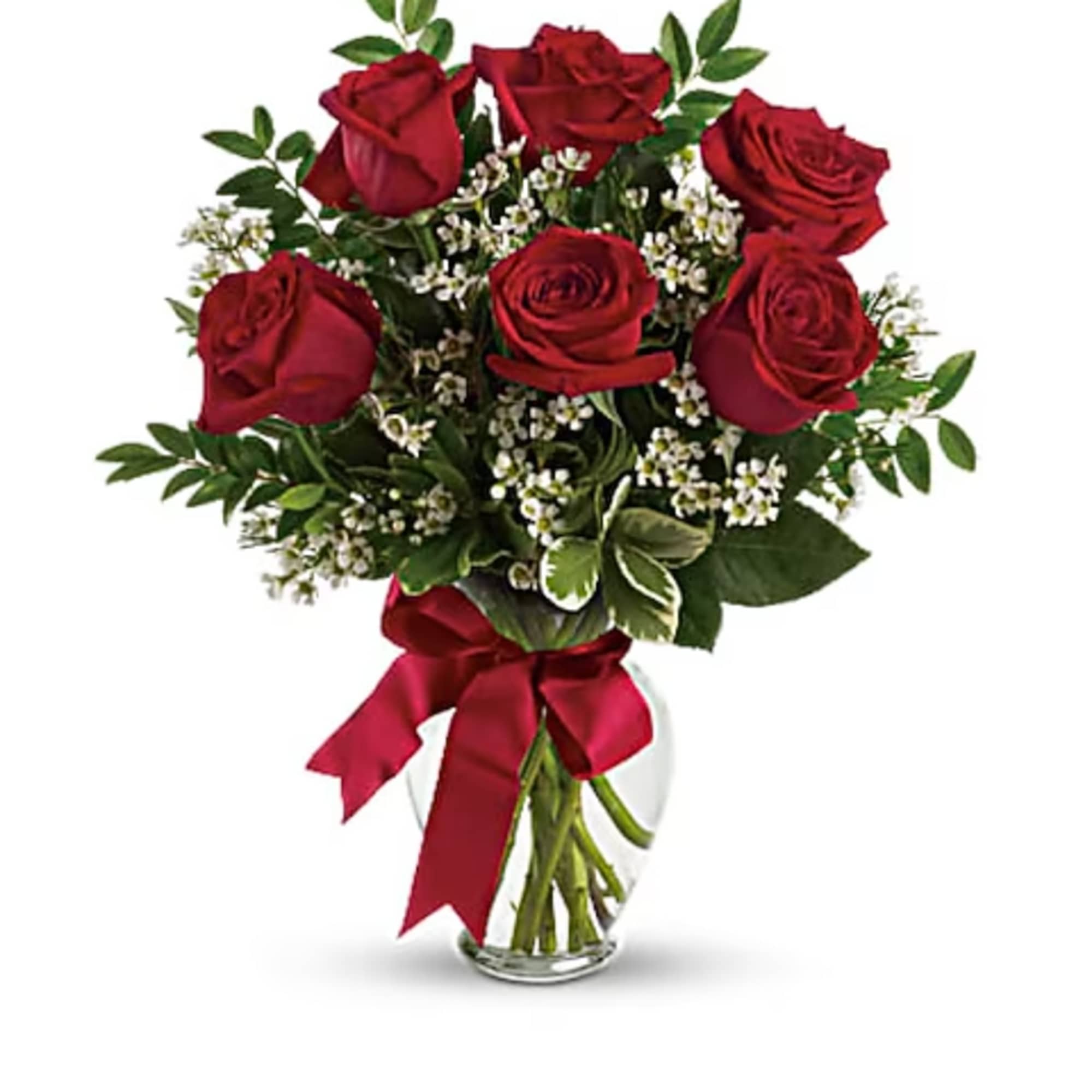 Bouquet of red roses with small white filler flowers in a glass vase