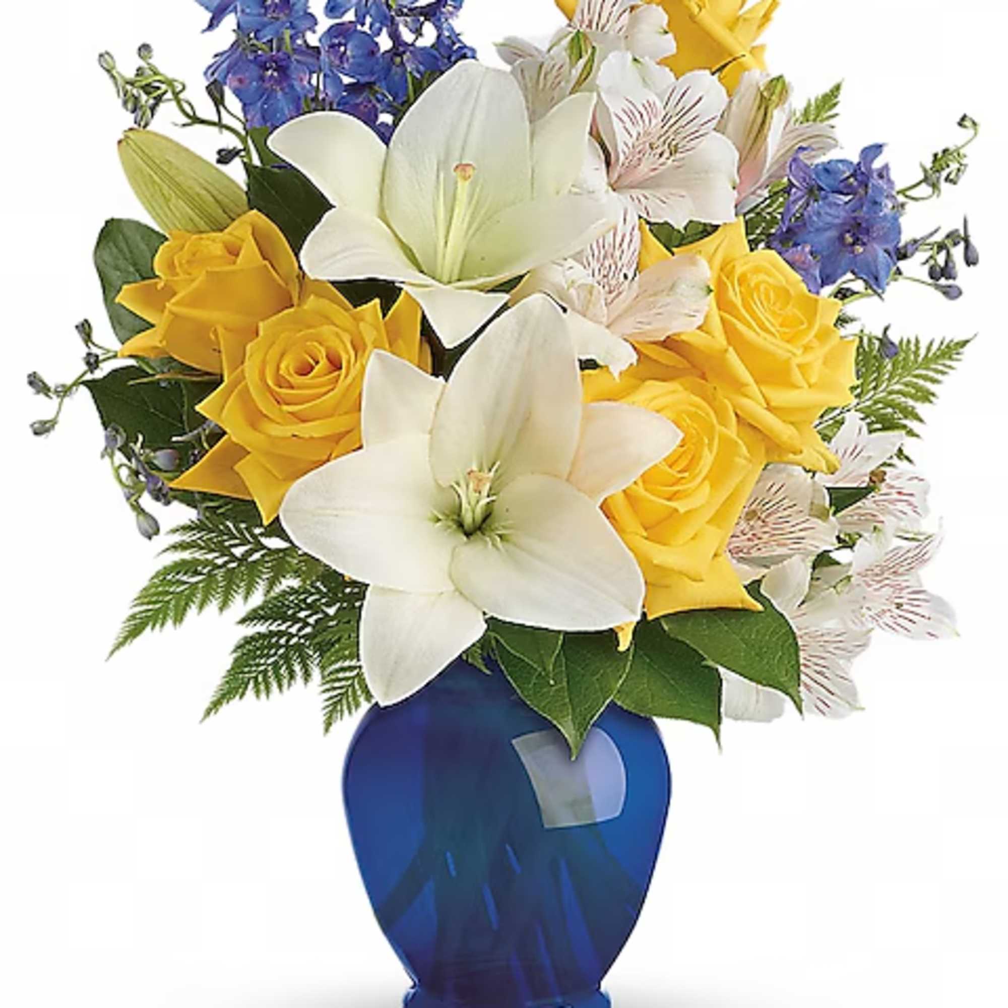 Yellow roses and white lilies in a blue vase with blue flowers