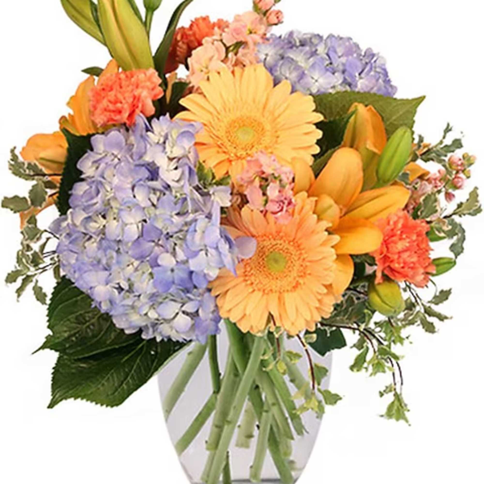 Mixed bouquet of orange and lavender flowers in a clear glass vase
