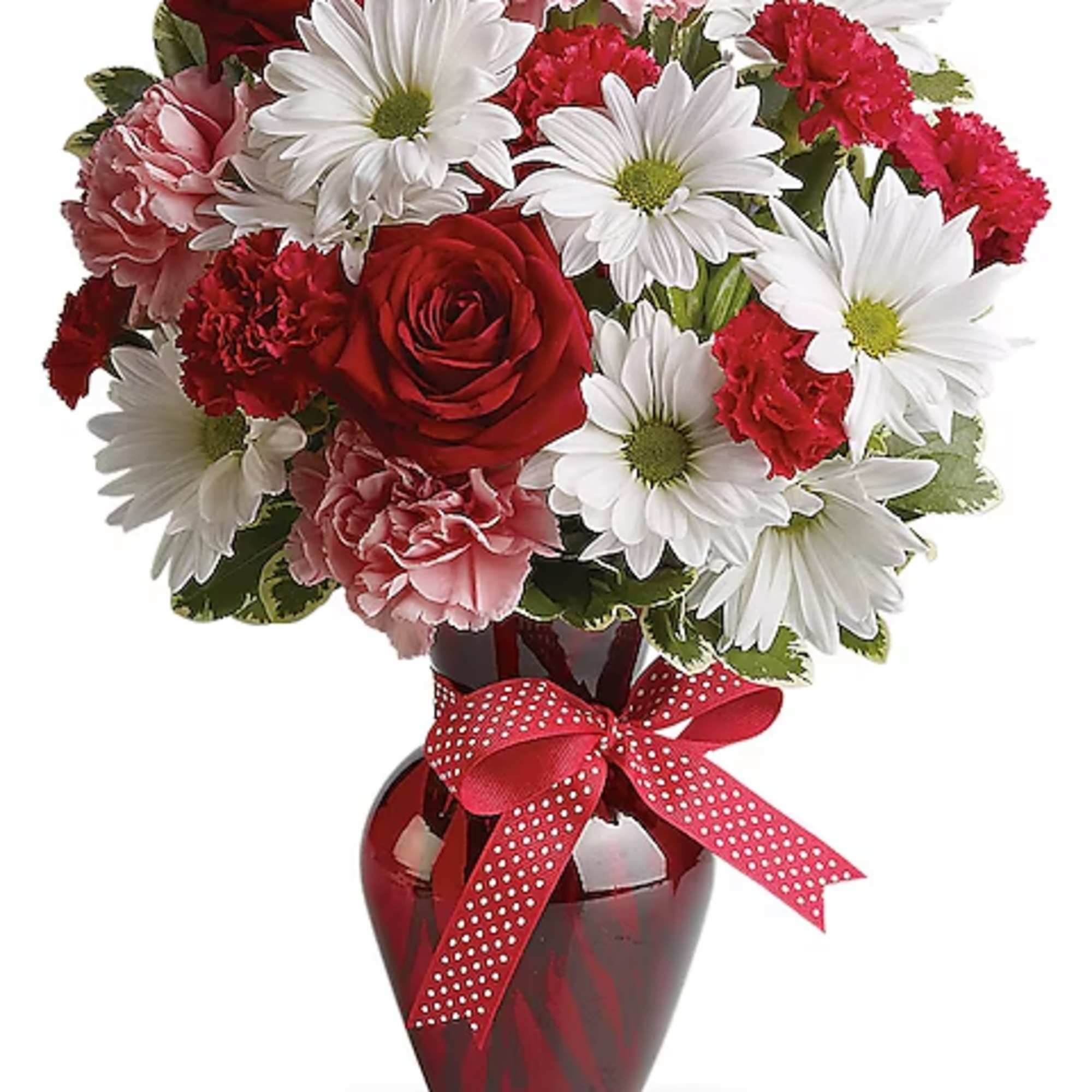 Bouquet of red roses, pink carnations, and white daisies in a red vase with a ribbon