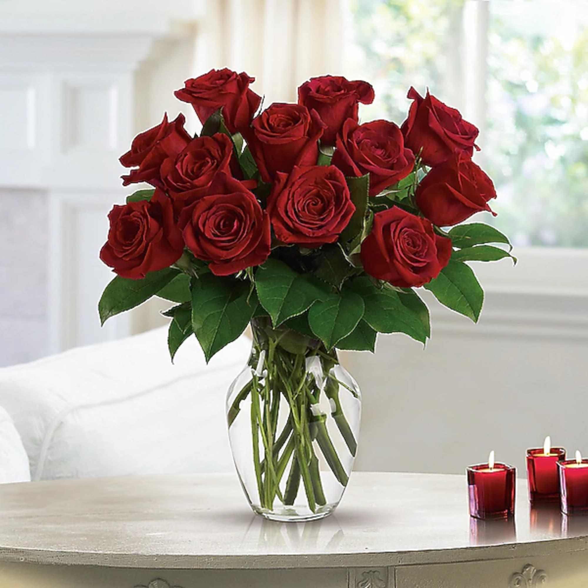 Bouquet of red roses in a clear glass vase, photo 2 of 2