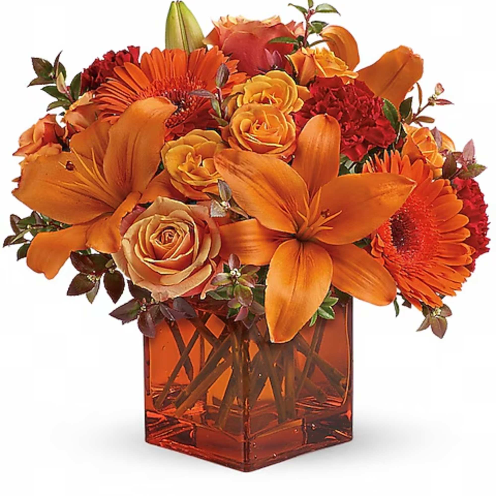 Orange floral arrangement in a square glass vase with roses, lilies, and gerbera daisies