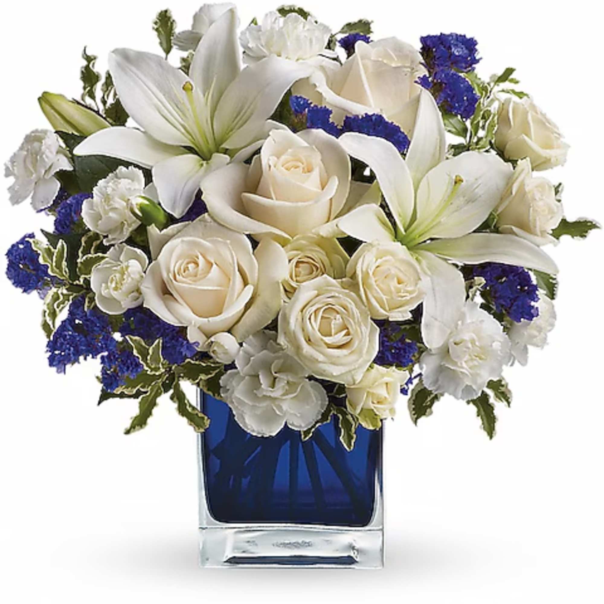 White lilies and roses arranged in a blue glass vase