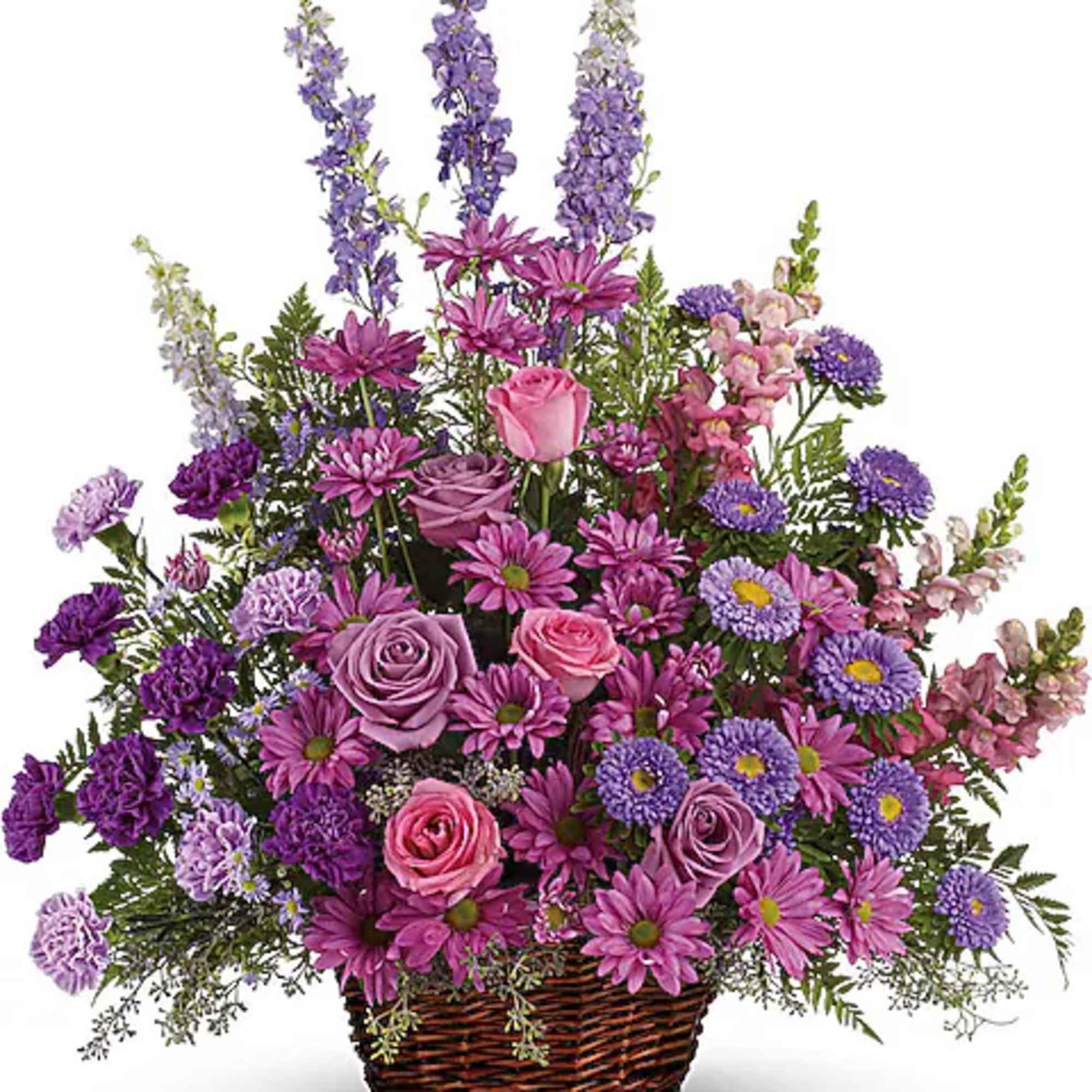 Basket arrangement of purple and pink flowers with tall lavender spikes