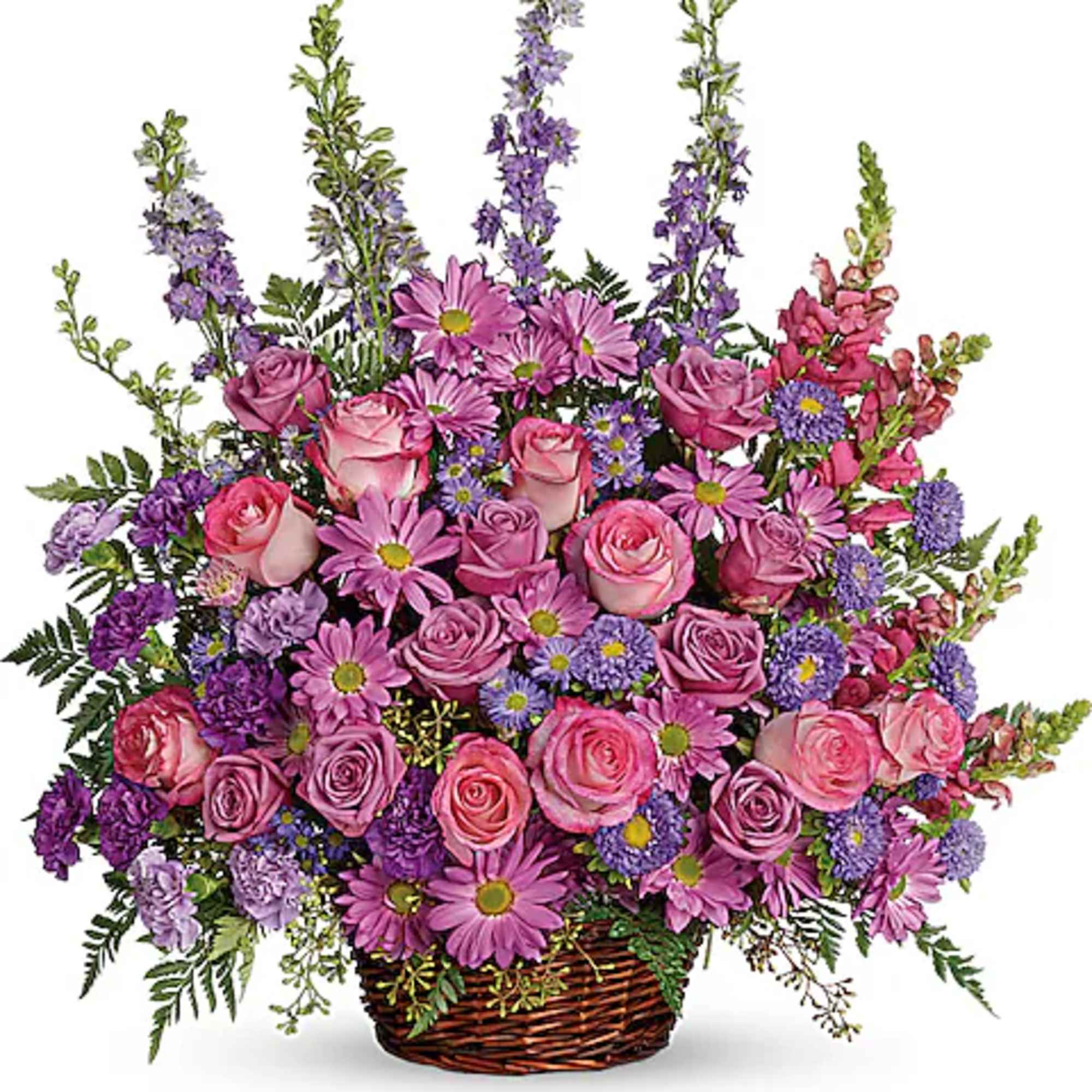 Pink and purple mixed flower arrangement in a wicker basket