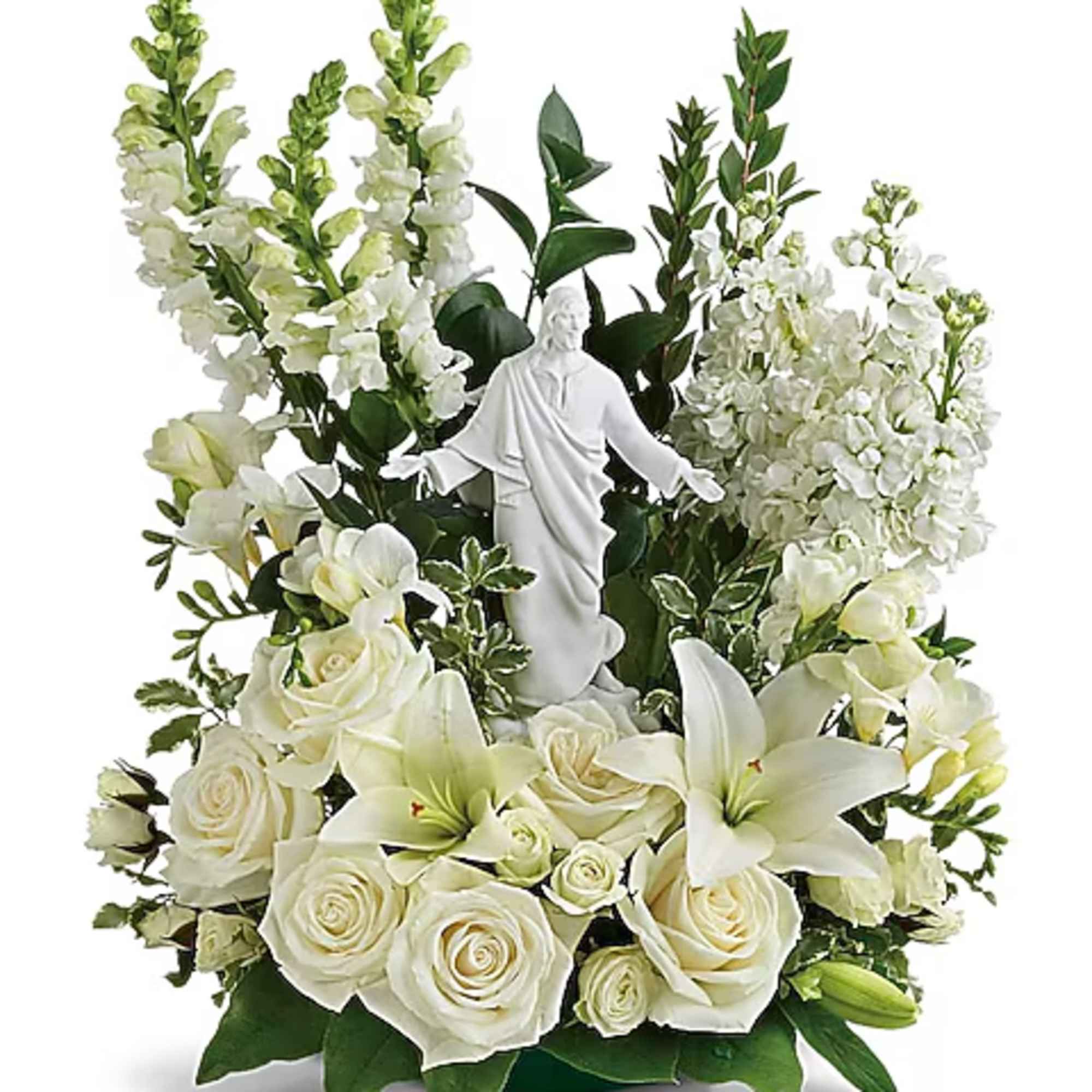 White floral arrangement with a small statue of Jesus in the center