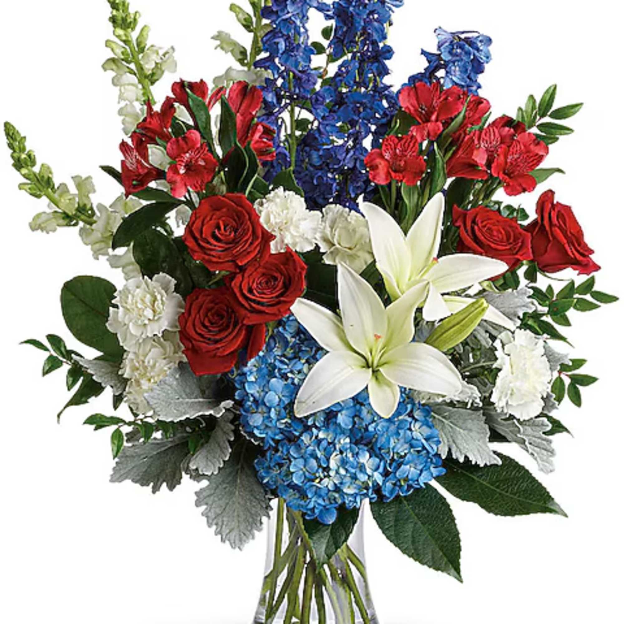 Bouquet of red roses, blue delphinium, white lilies, and hydrangeas in a glass vase
