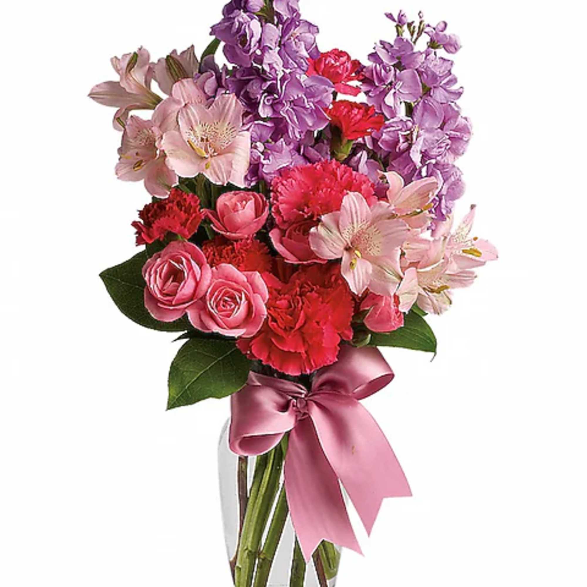Pink and purple mixed bouquet in a clear glass vase with a satin ribbon