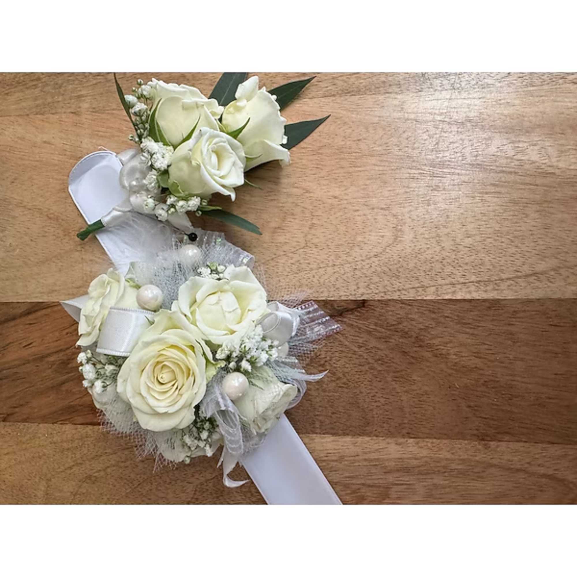 White rose corsages with ribbon and pearl accents