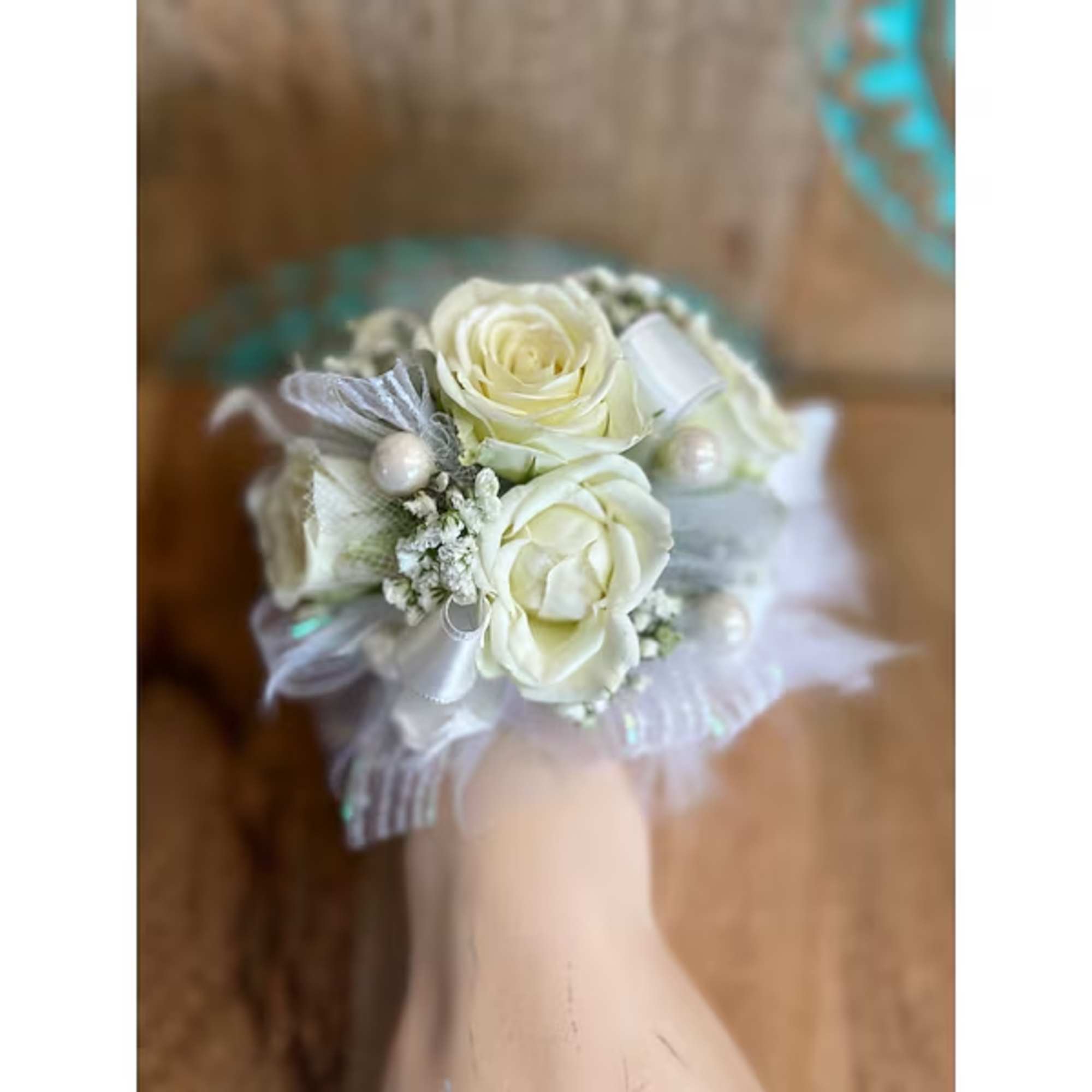 Small white rose corsage with ribbon and pearl accents