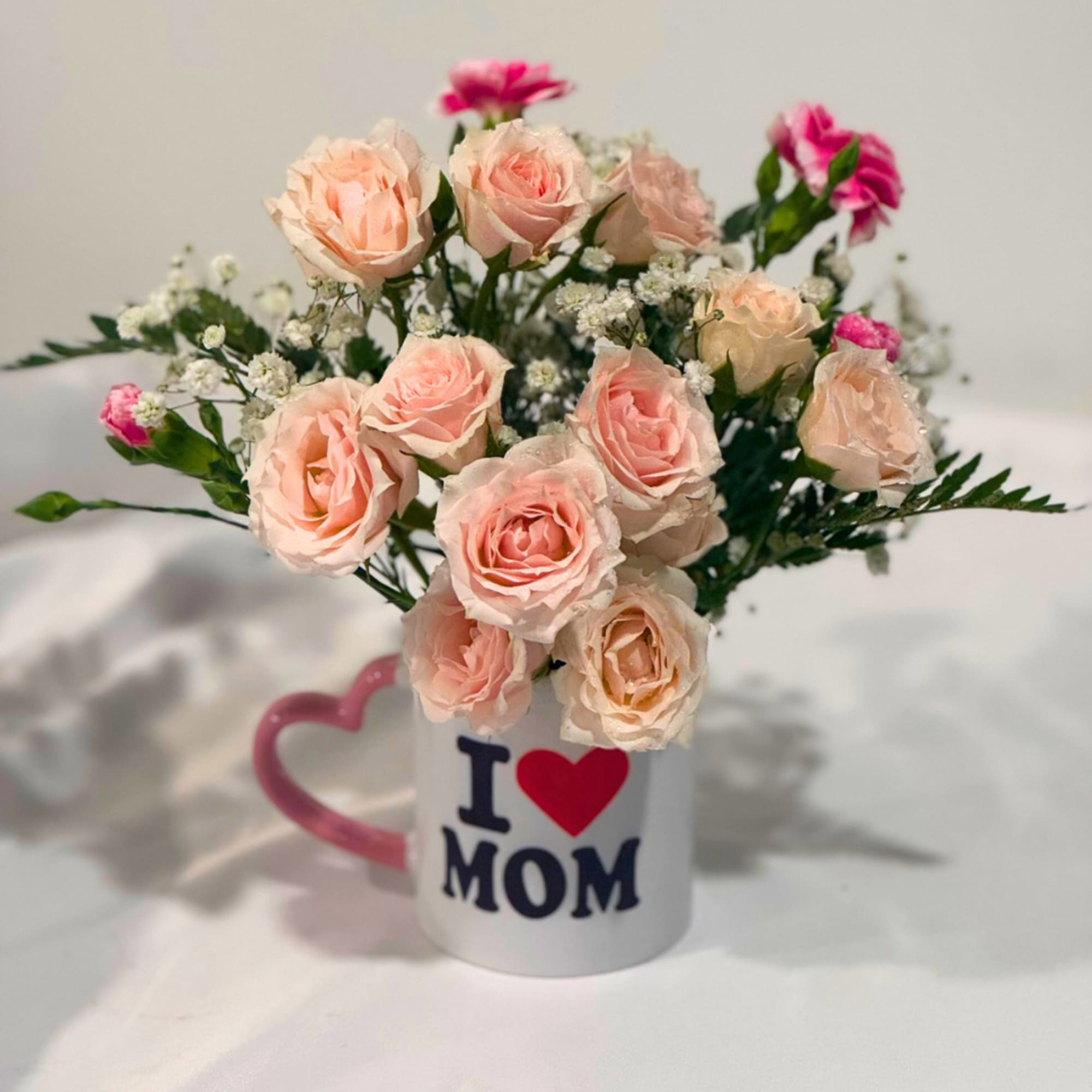Pink roses in a mug that says I love Mom