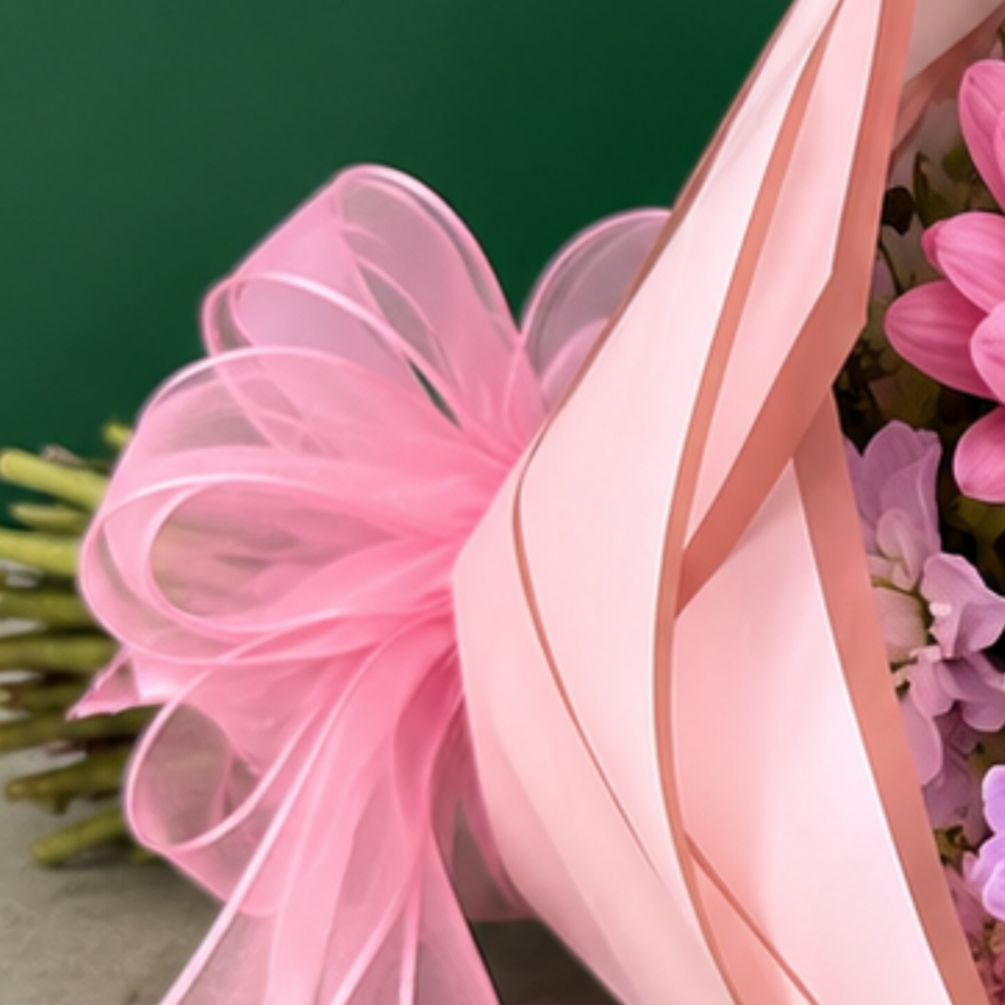 Pink flowers wrapped with a large pink ribbon bow