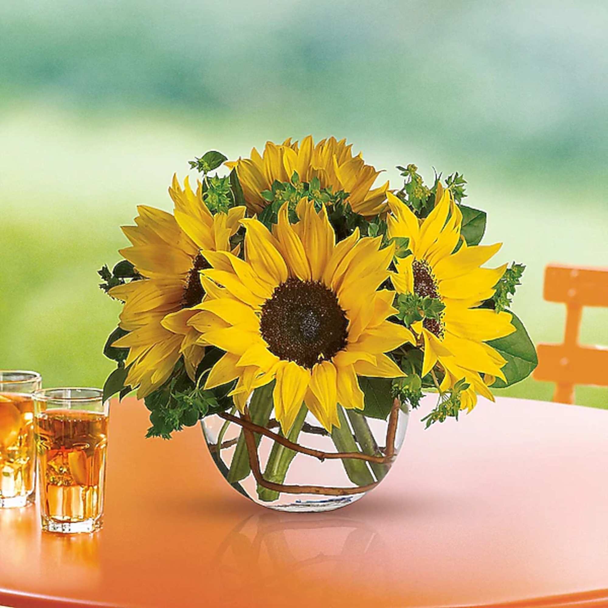 Sunflower bouquet in a clear glass vase on a table