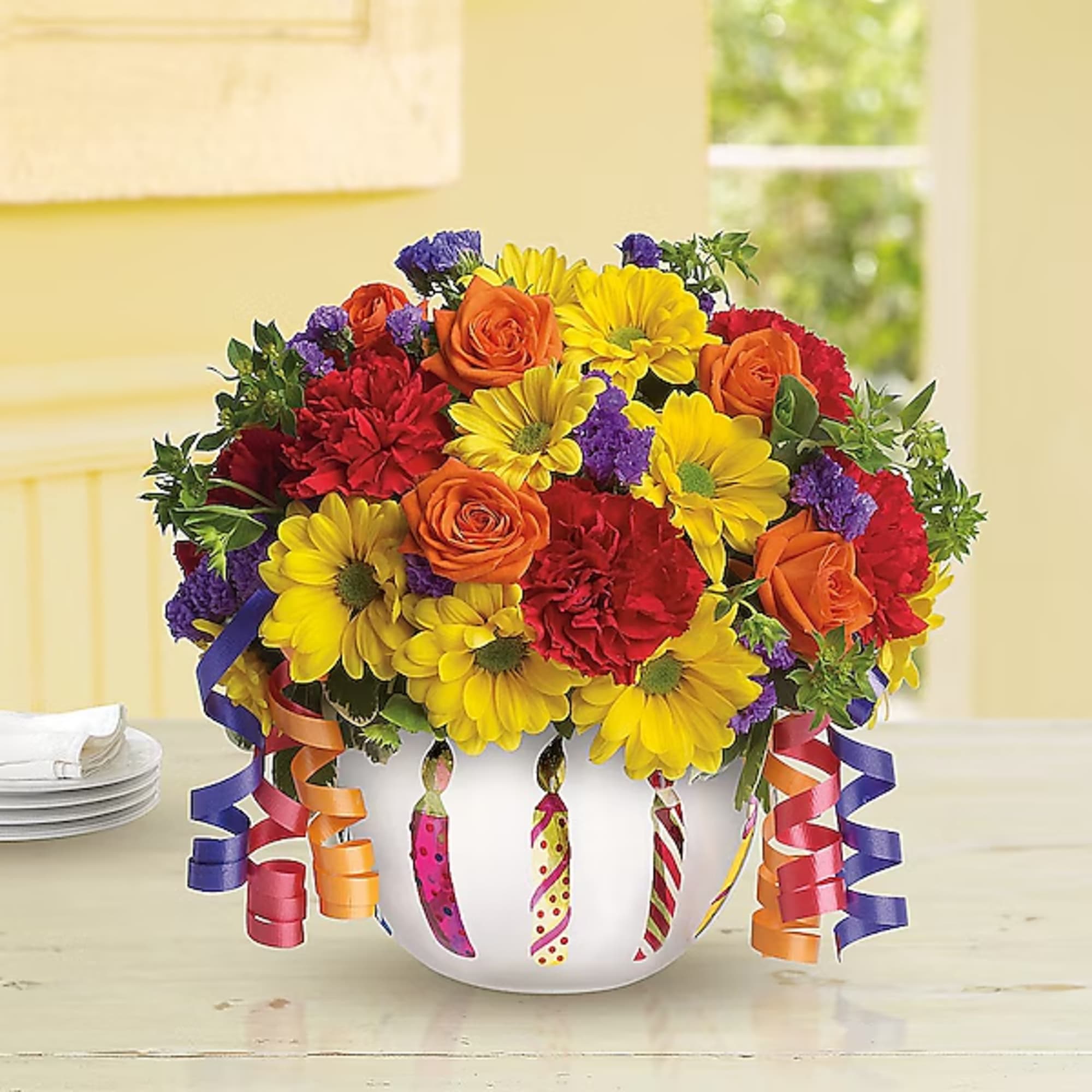 Colorful bouquet in a white vase with ribbon streamers