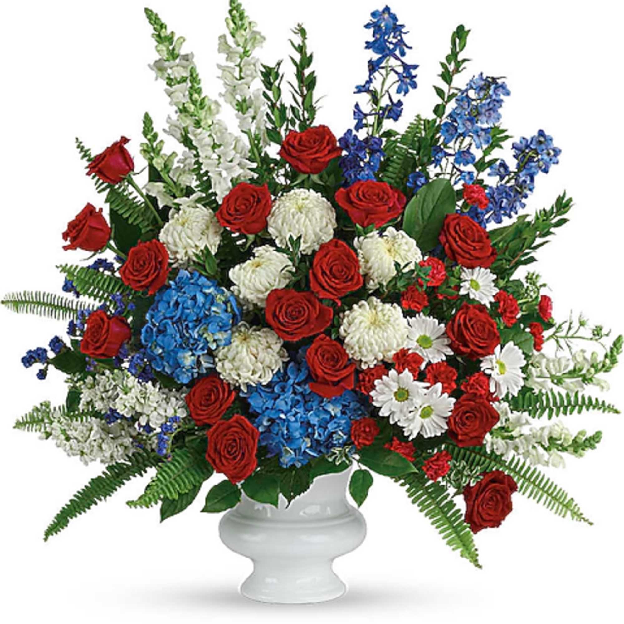 Red roses, blue and white flowers in a white urn vase
