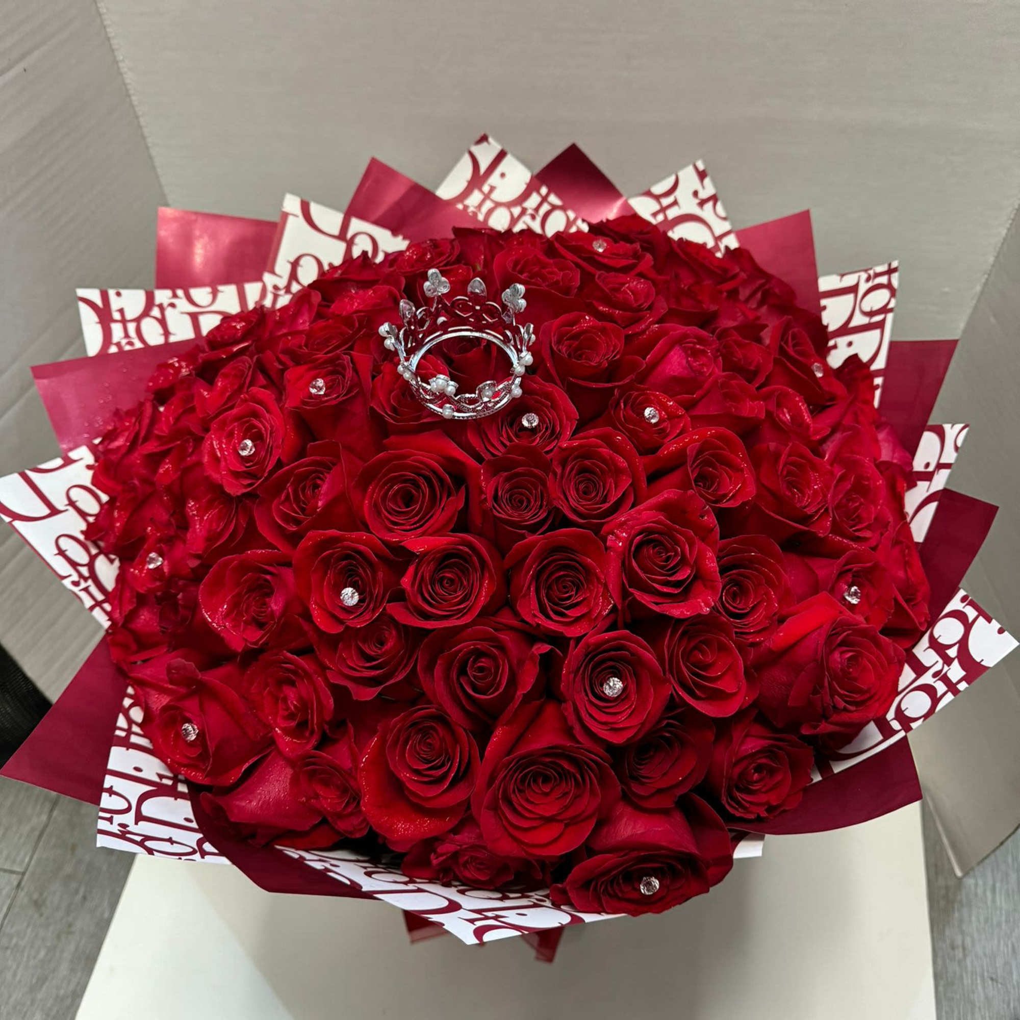 In this bouquet of 100 red roses, romance overflows like a river