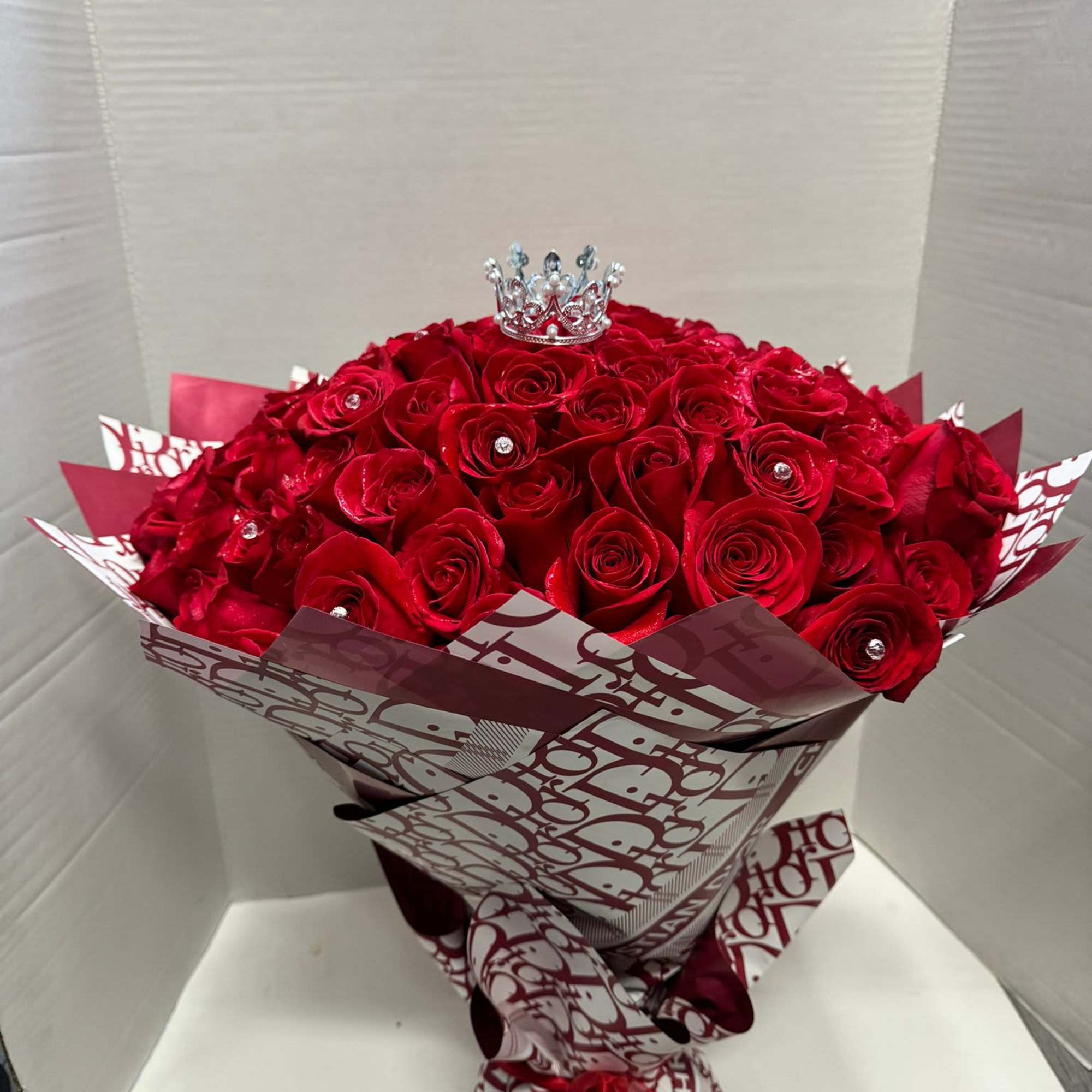 In this bouquet of 100 red roses, romance overflows like a river, photo 2 of 2