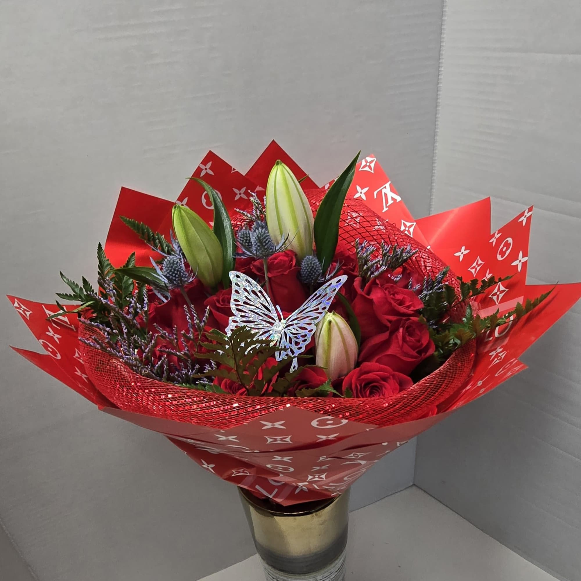 Our vibrant red bouquet of 24 roses and lilies adds elegance and, photo 2 of 2
