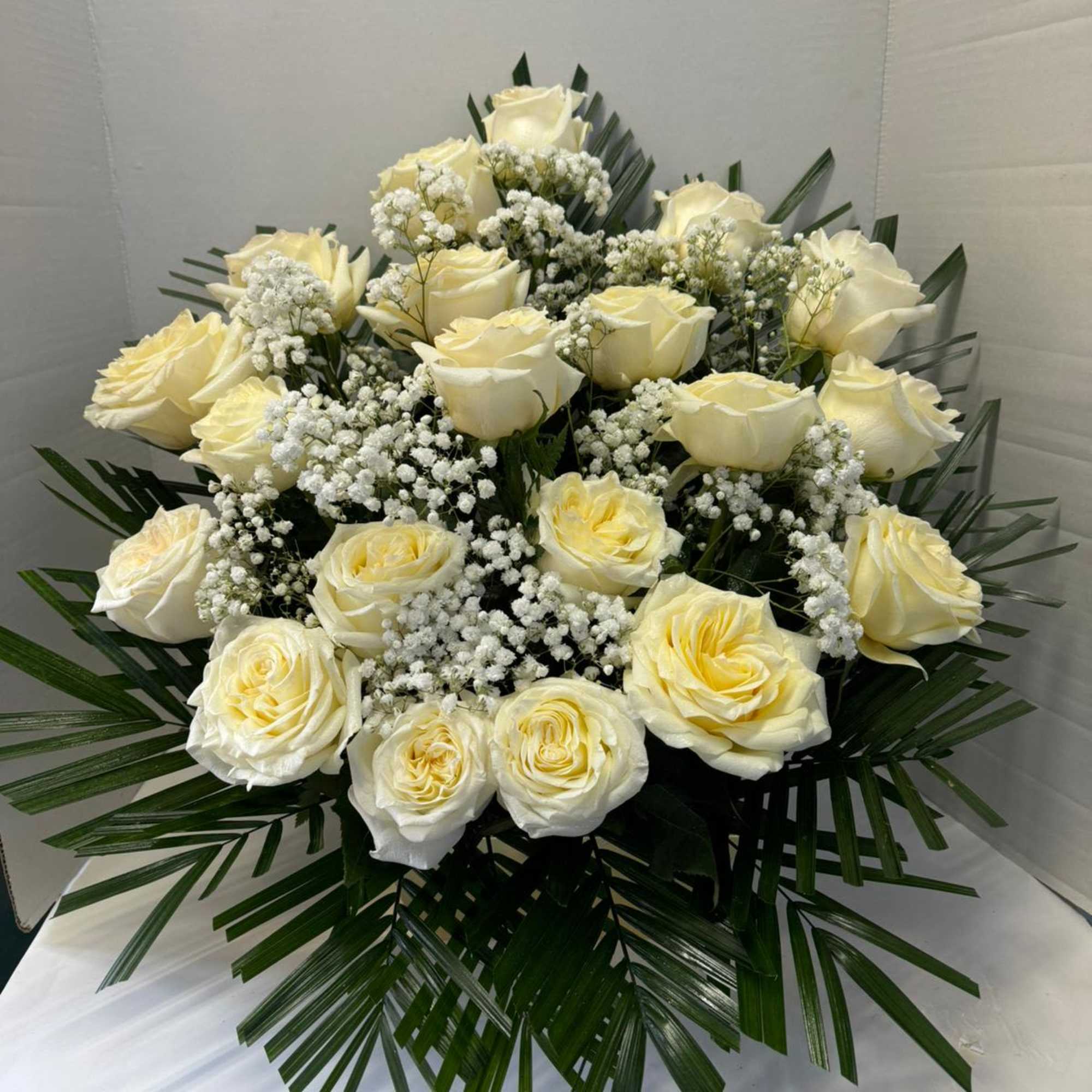 24 white roses combined with green foliage
