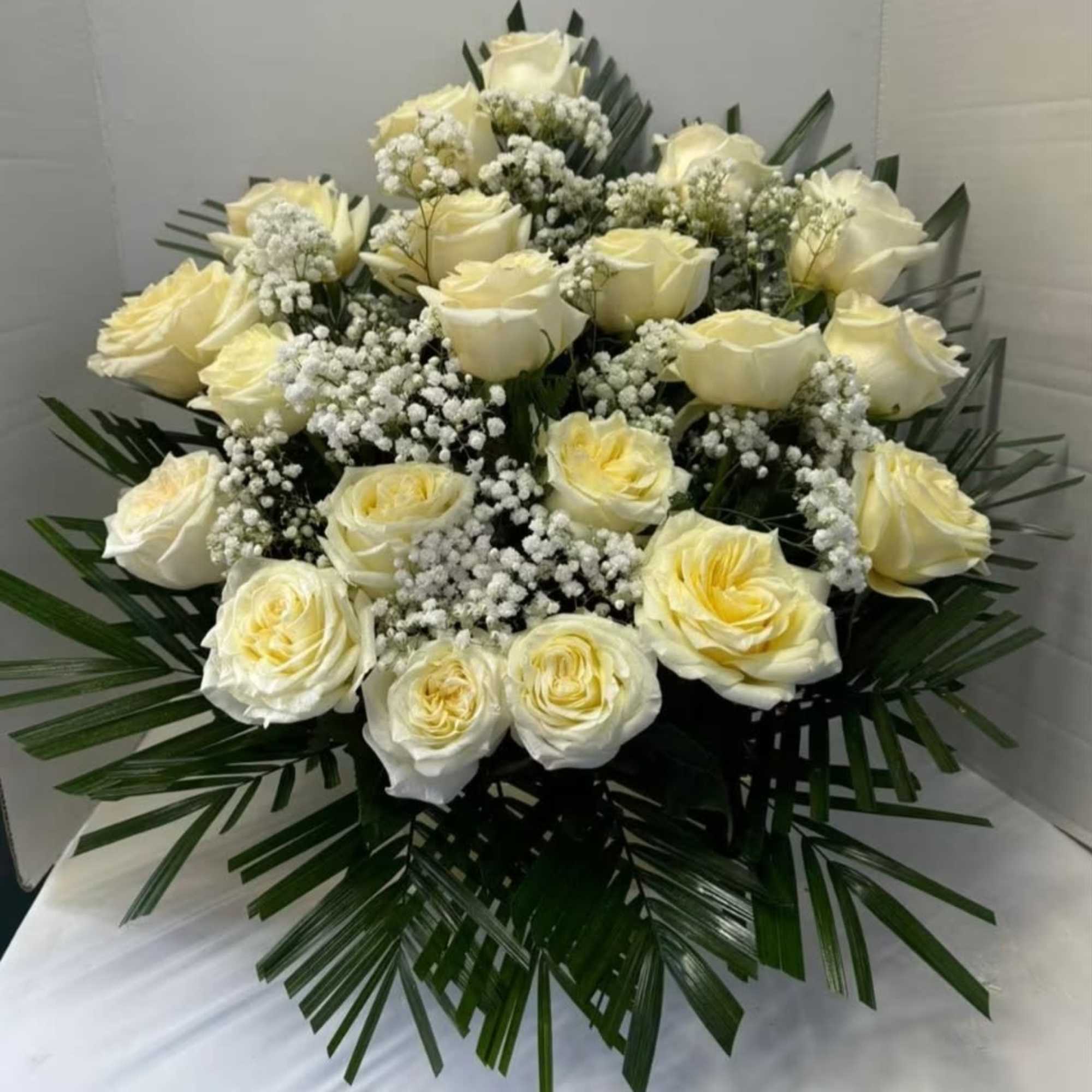 24 white roses combined with green foliage, photo 2 of 2