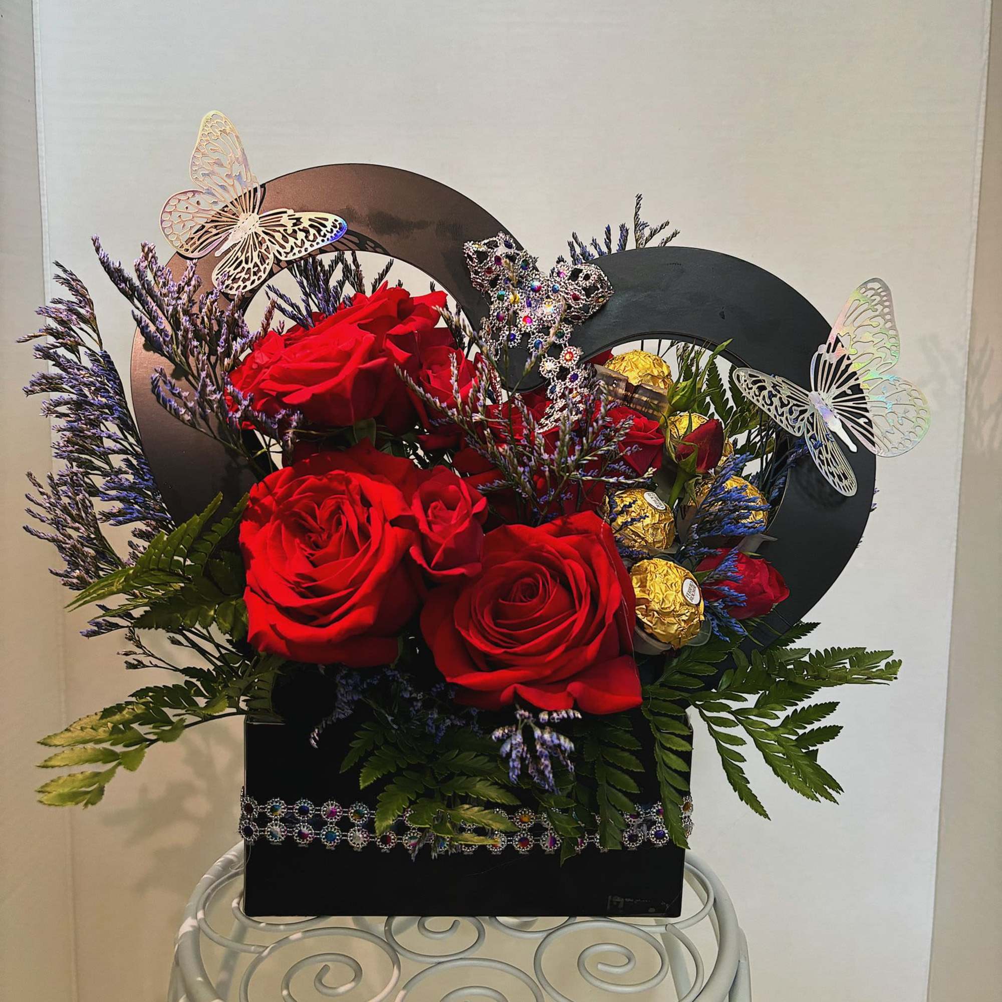 This arrangement is made with roses and chocolates. It is a small, photo 2 of 2
