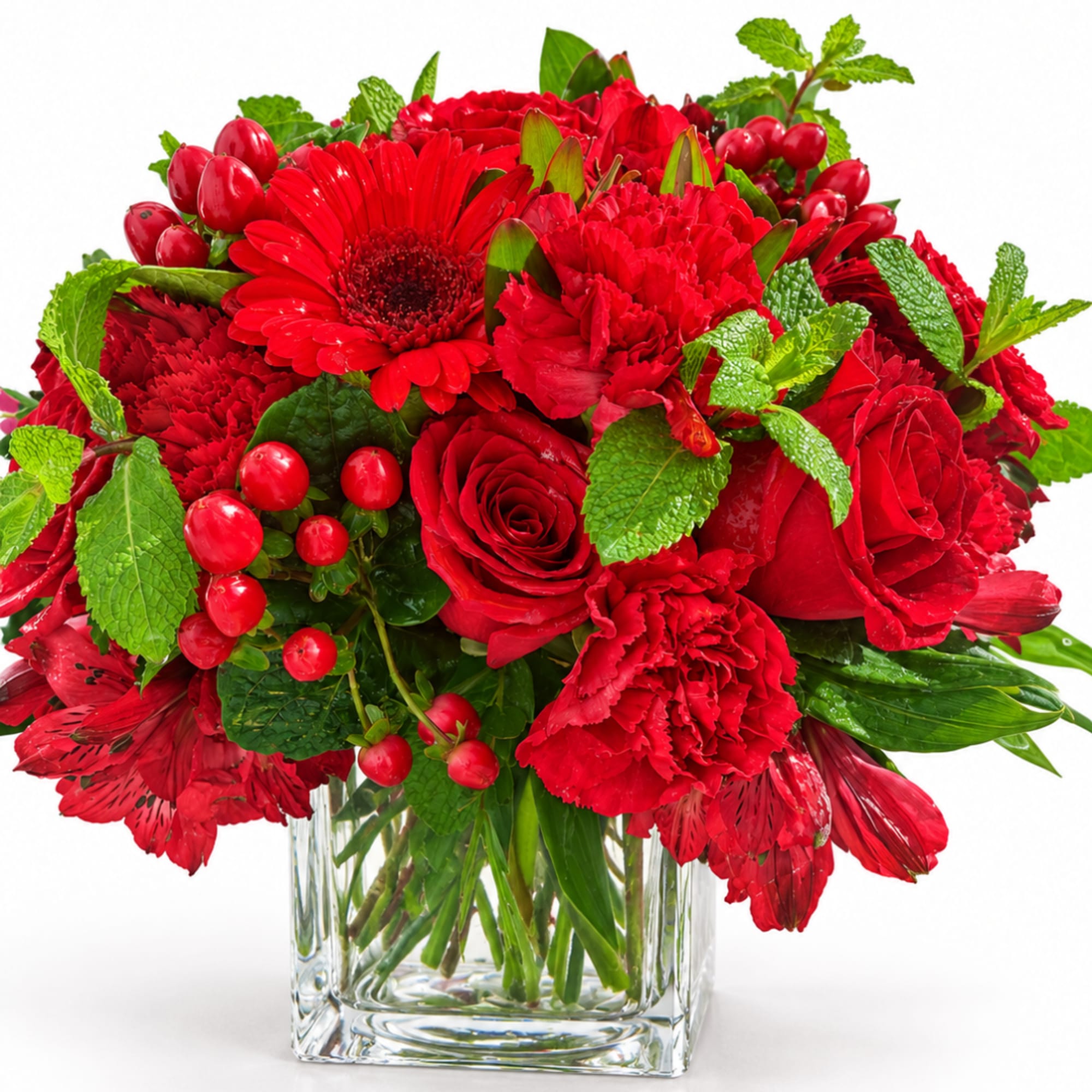 Red mixed flower bouquet in a clear glass vase