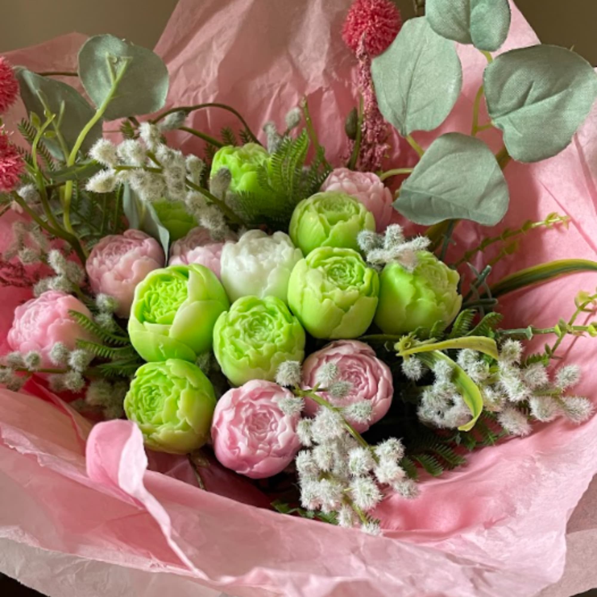 Bouquet of pink and green flowers wrapped in pink paper