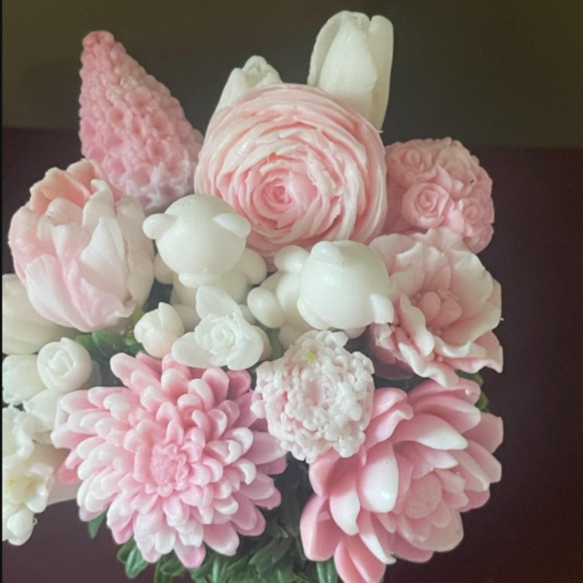 Pink and white floral arrangement with layered blooms in a bouquet.