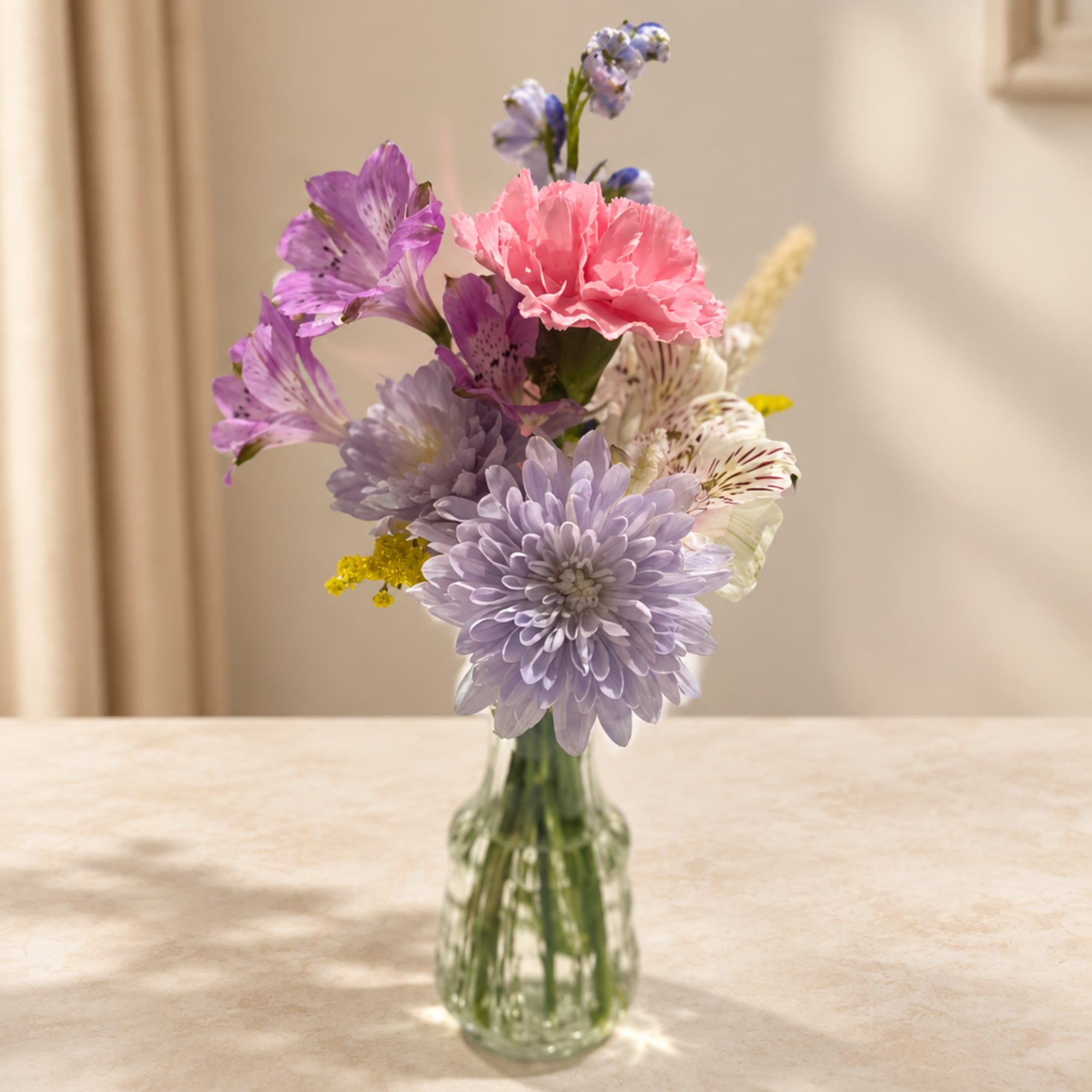Mixed pastel bouquet in a clear glass vase