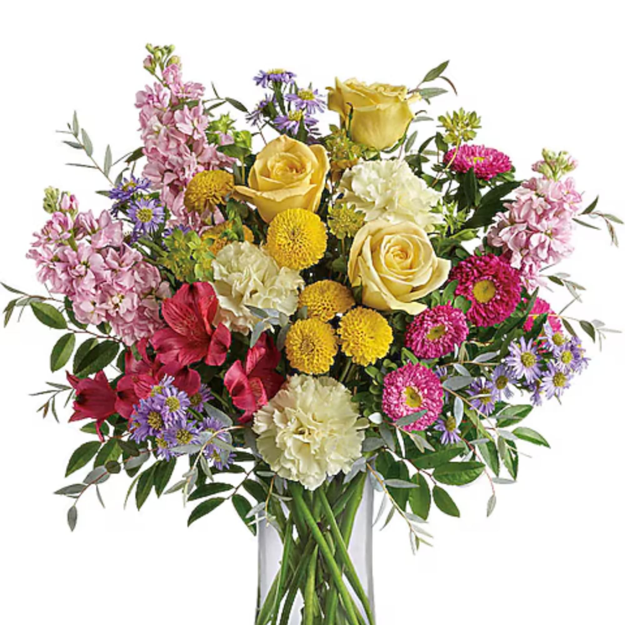 Mixed bouquet of yellow roses, pink flowers, and purple daisies in a clear vase