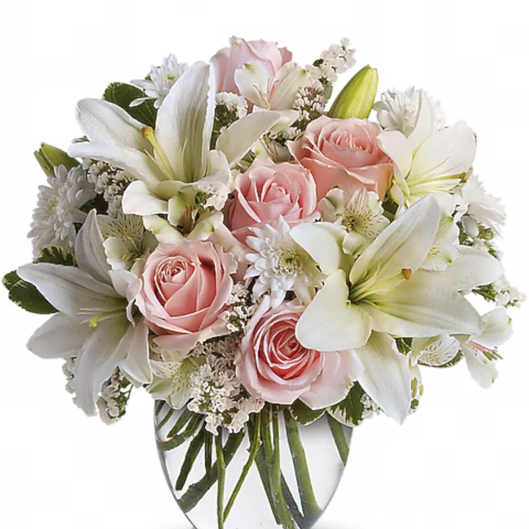 Pink roses and white lilies arranged in a clear glass vase