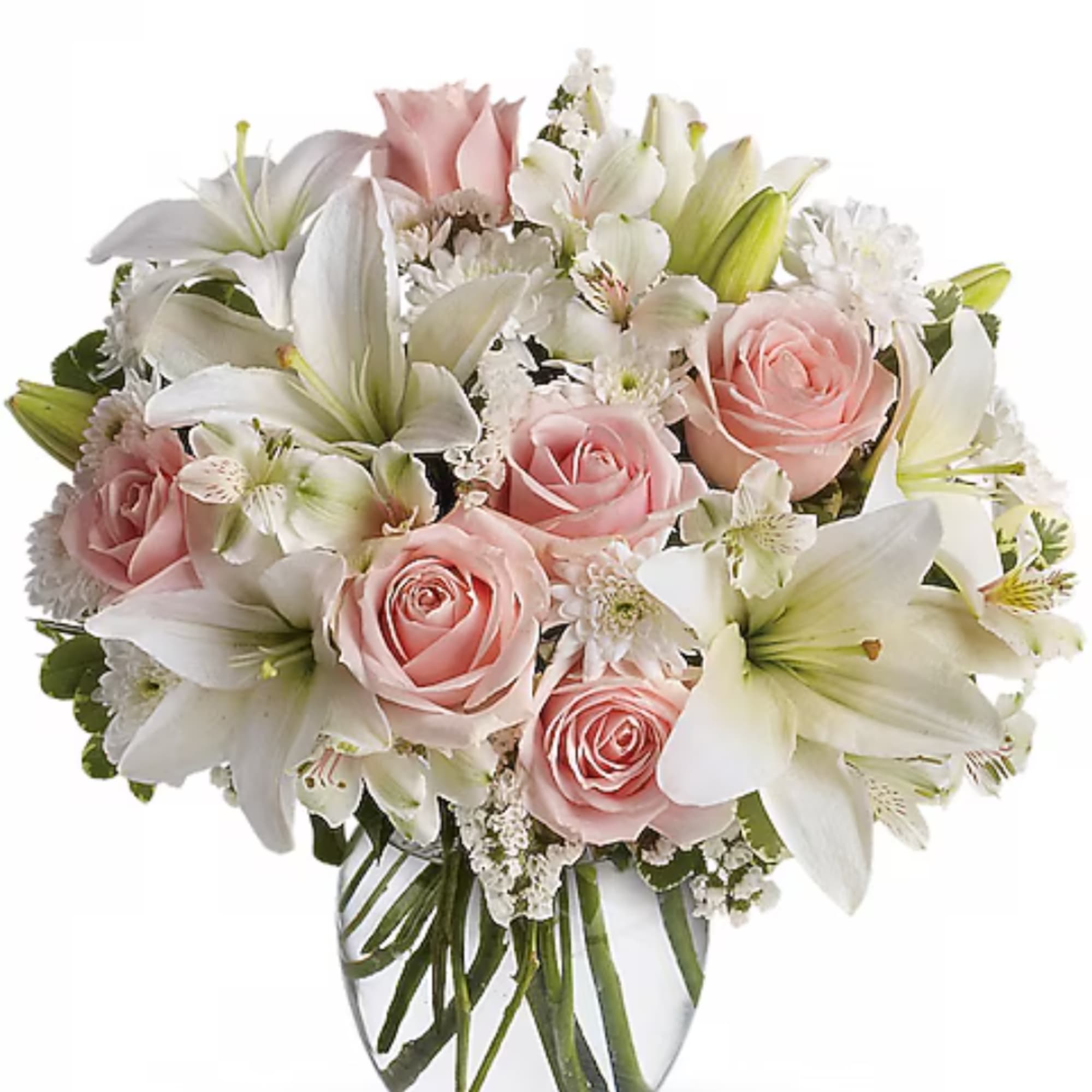 Pink roses and white lilies arranged in a clear glass vase