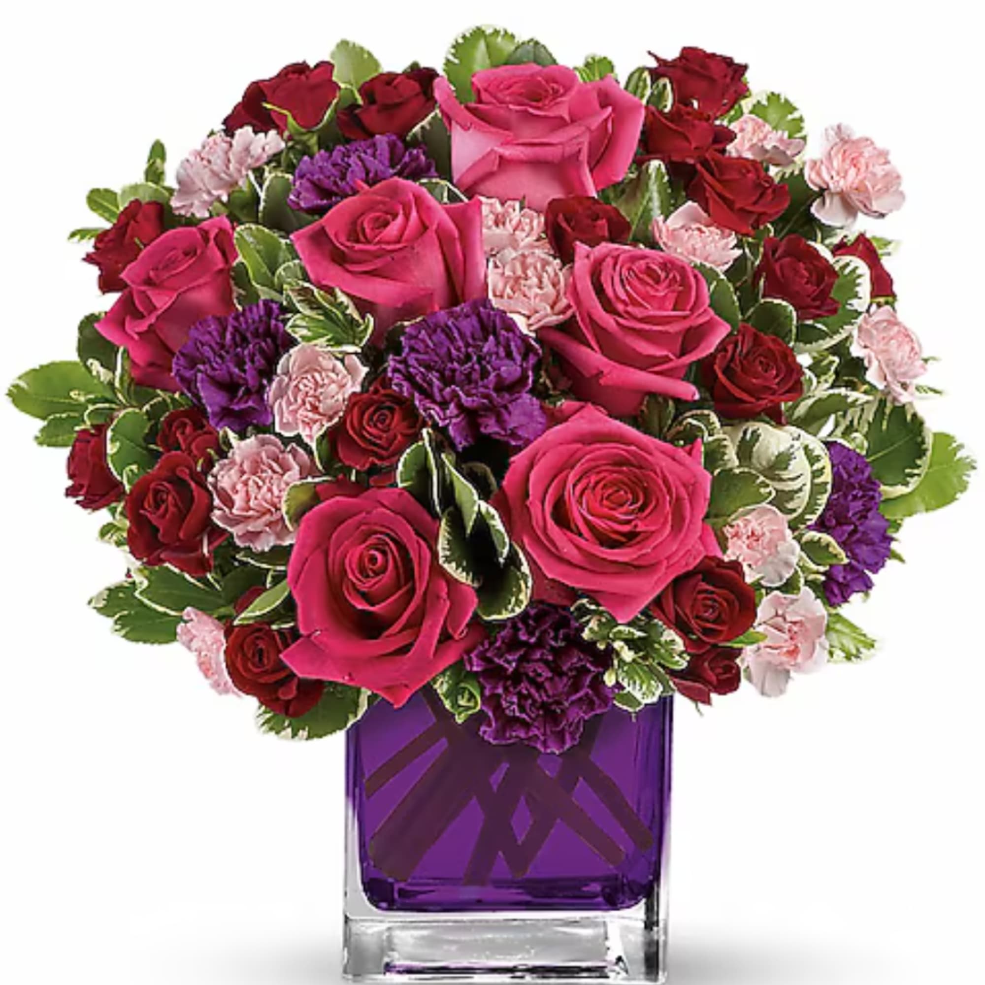 Pink and red rose bouquet in a purple glass vase