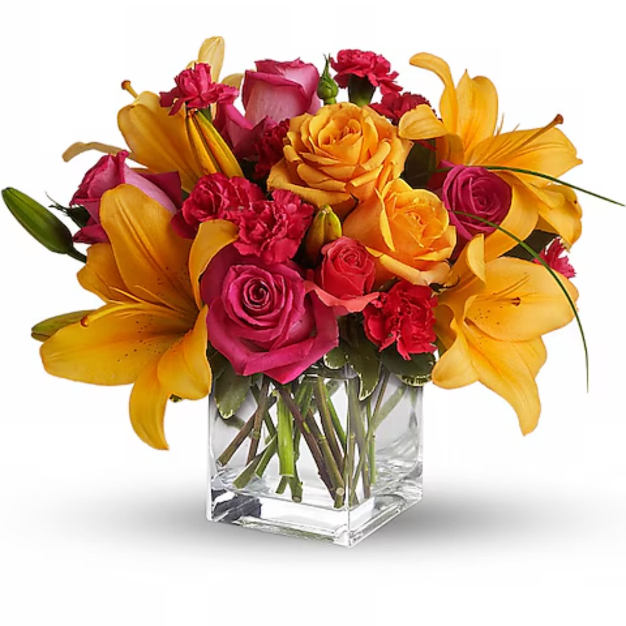 Bouquet of yellow lilies, pink roses, and red carnations in a clear glass vase