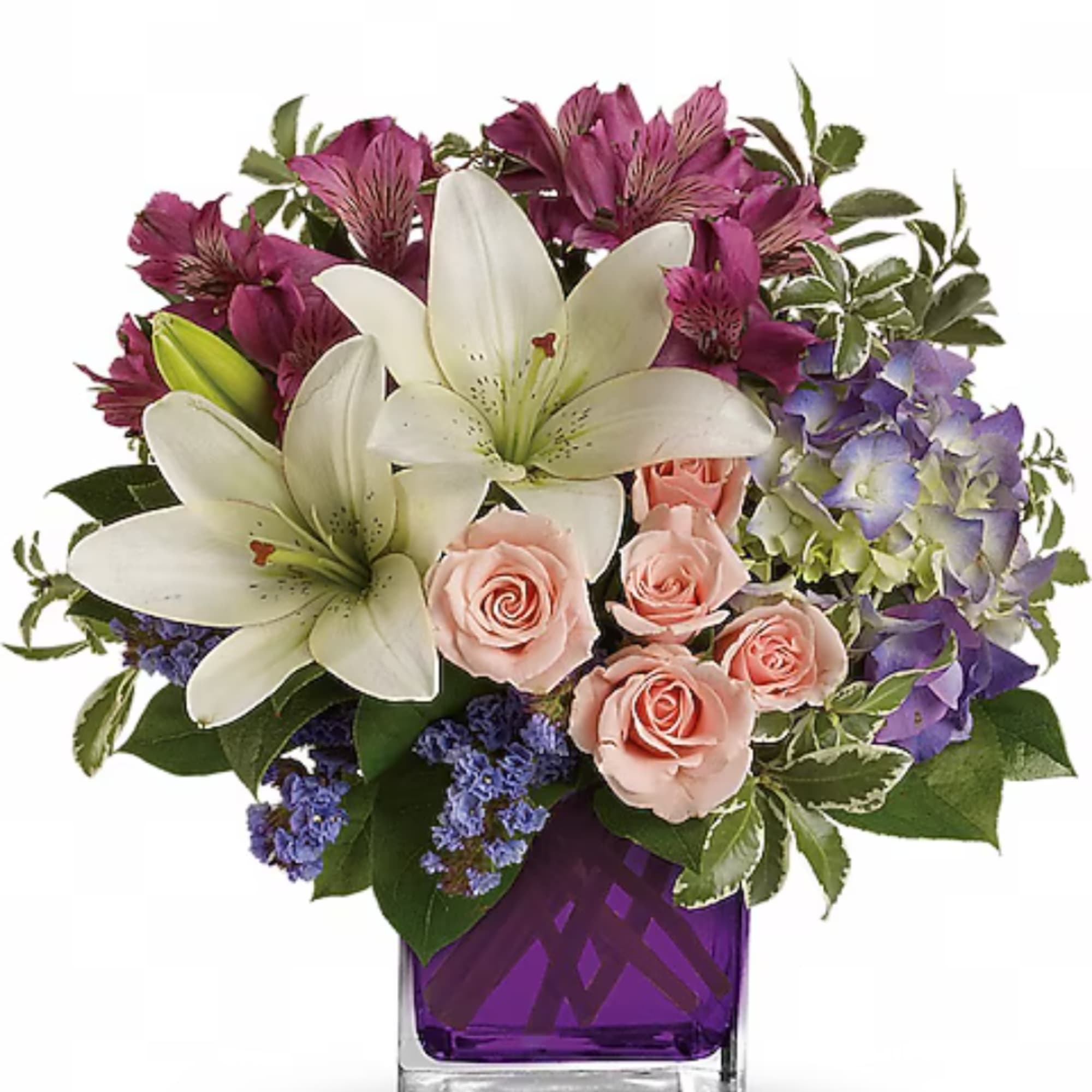 Bouquet of white lilies, pink roses, and purple flowers in a purple vase