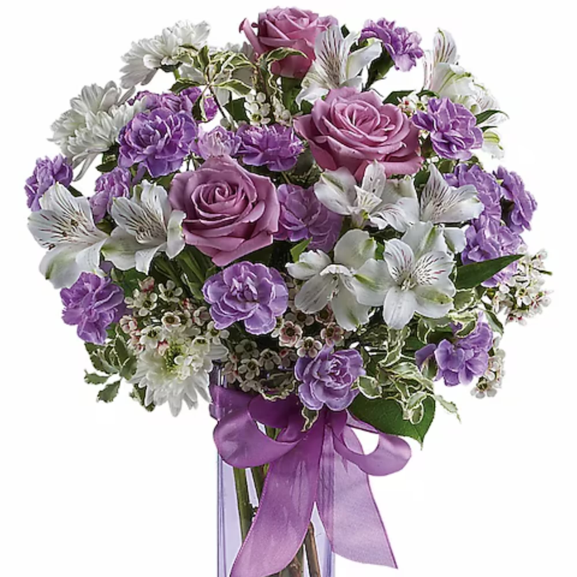 Purple and white bouquet with roses and lilies in a clear vase