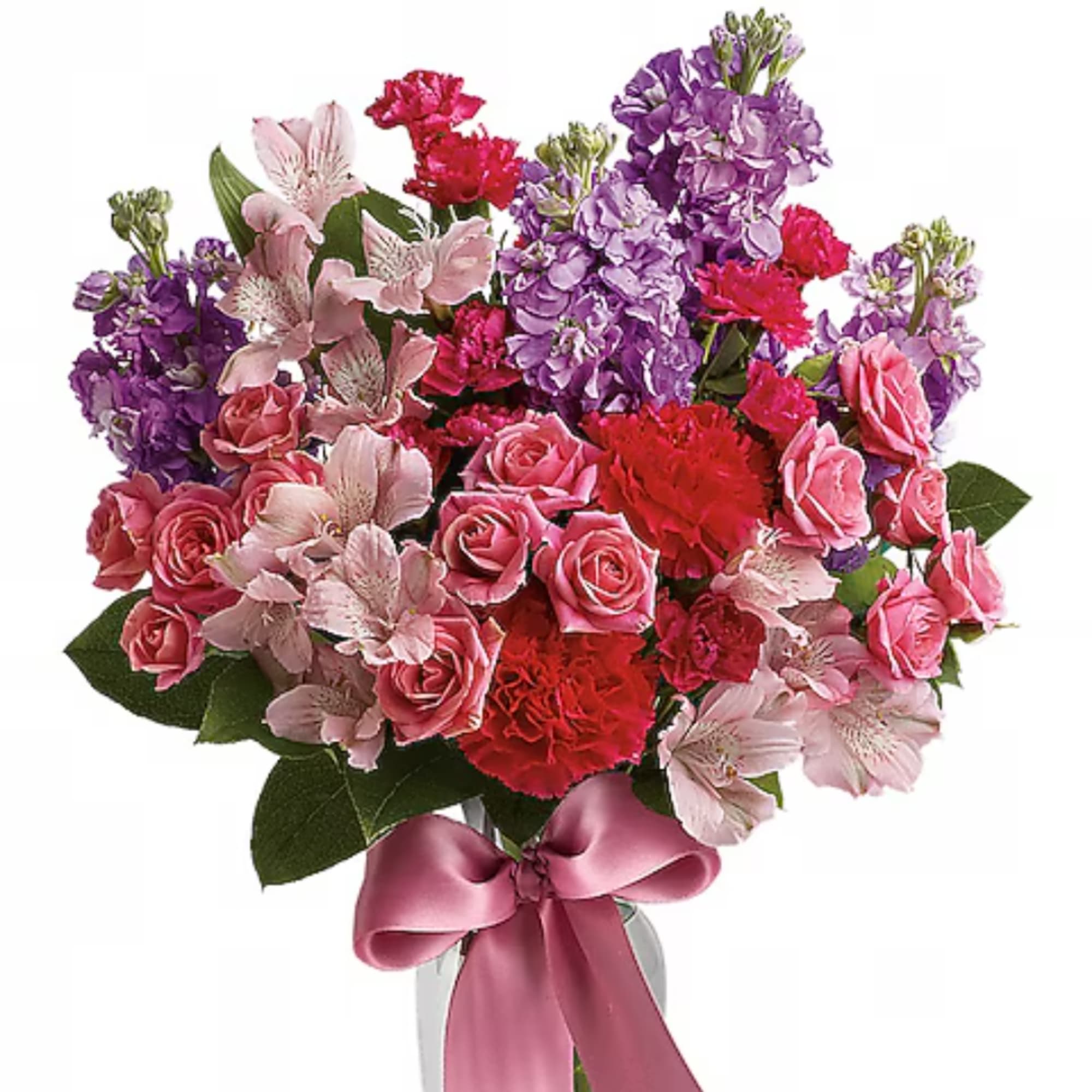 Bouquet of pink roses, carnations, and purple flowers in a vase with a pink ribbon