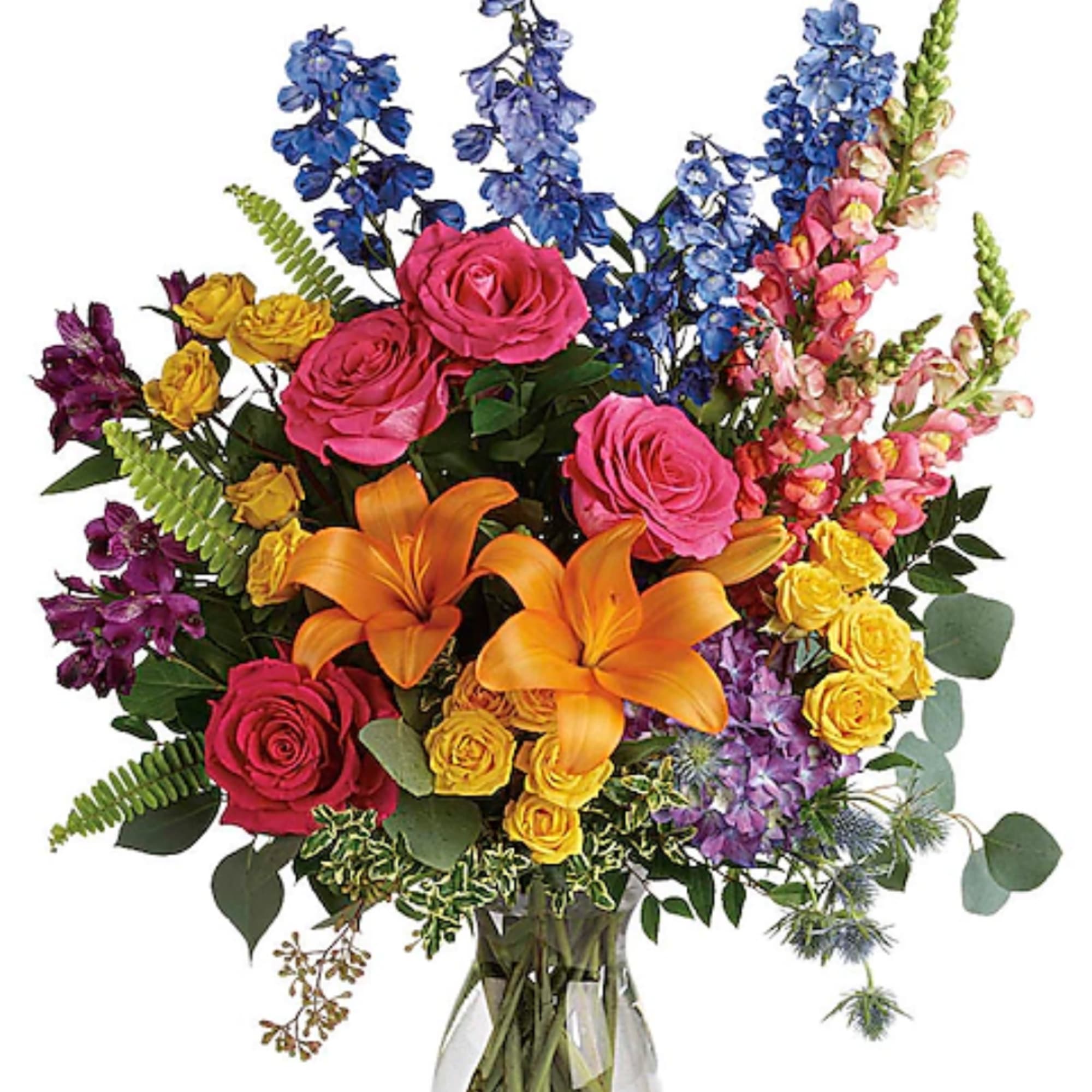 Colorful bouquet with roses, lilies, and blue flowers in a glass vase