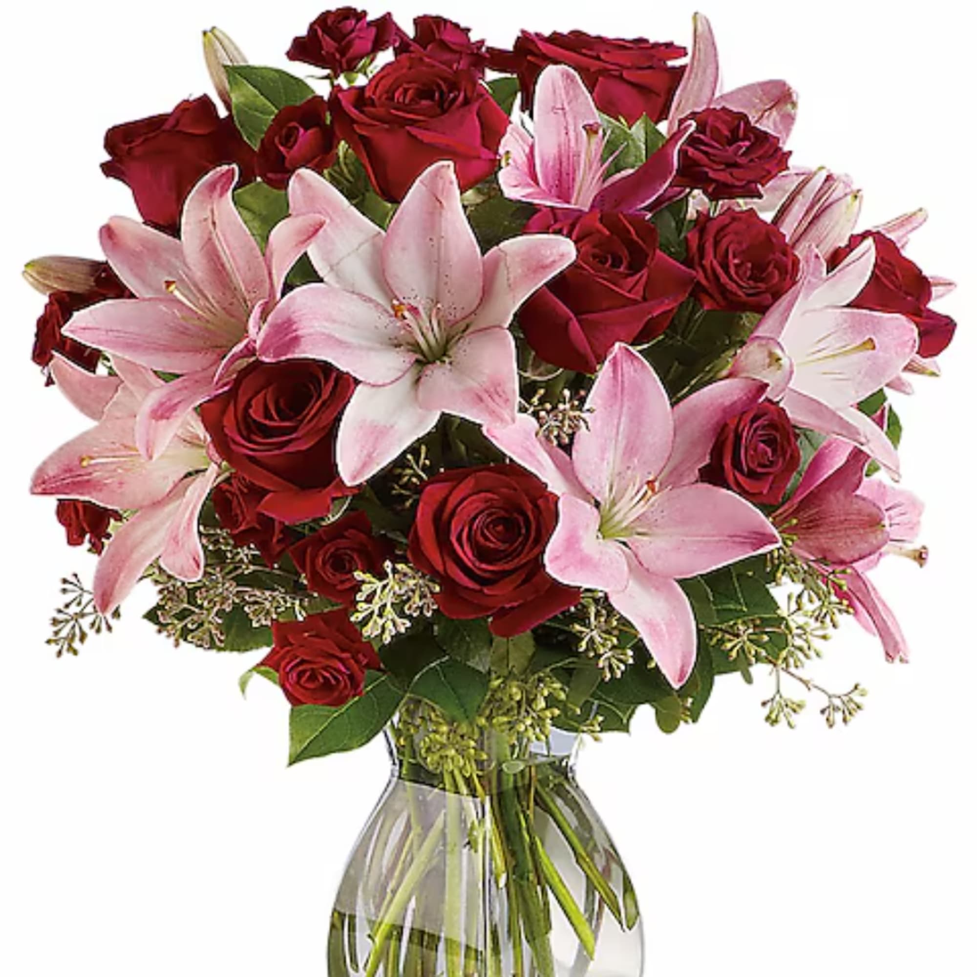 Red roses and pink lilies arranged in a clear glass vase