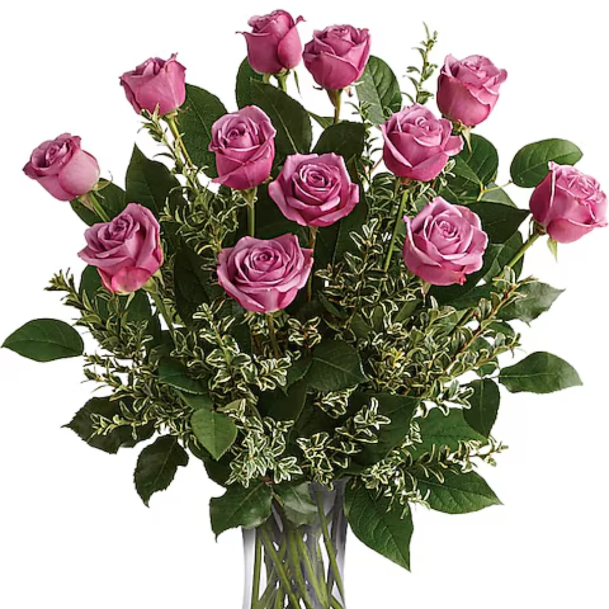 Bouquet of pink roses with mixed greenery in a clear glass vase