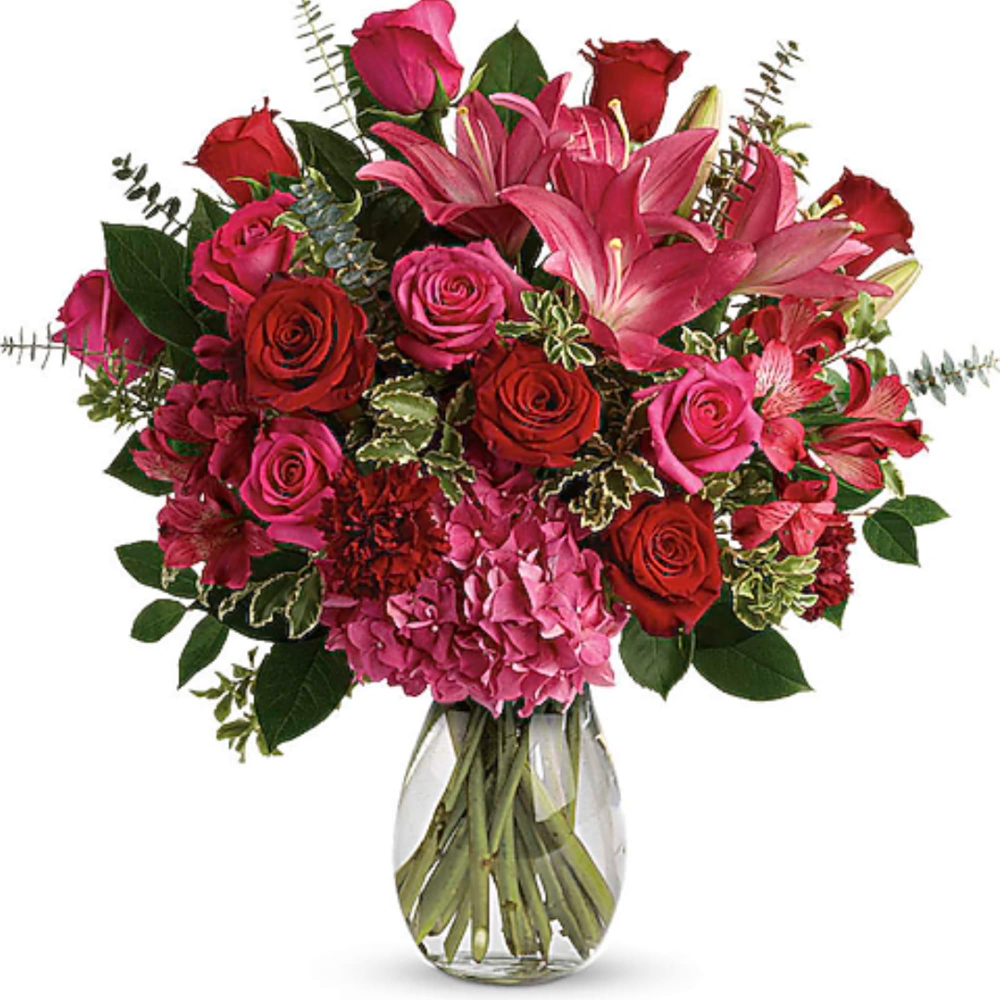 Pink and red mixed bouquet with roses, lilies, and hydrangea in a glass vase