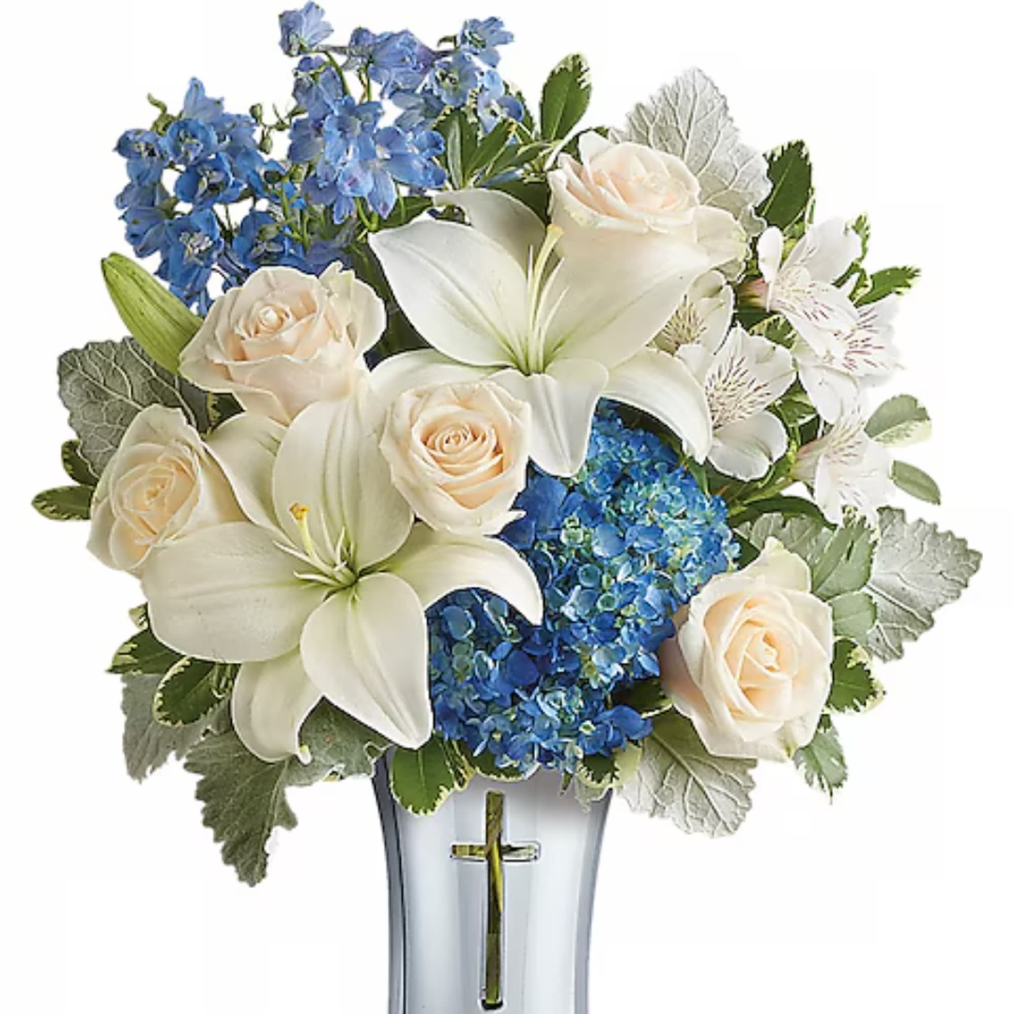 White lilies and cream roses with blue hydrangeas in a vase with a cross.