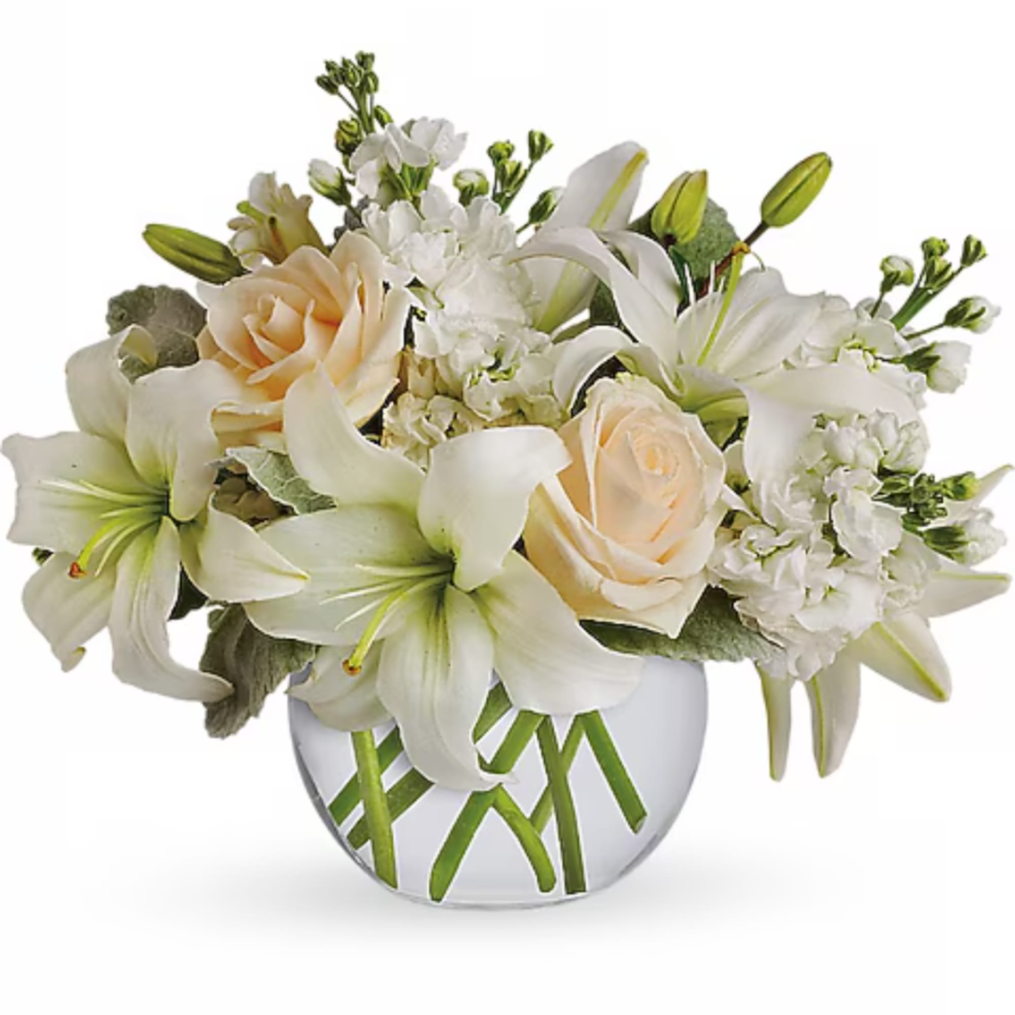 White lilies and cream roses arranged in a clear glass vase