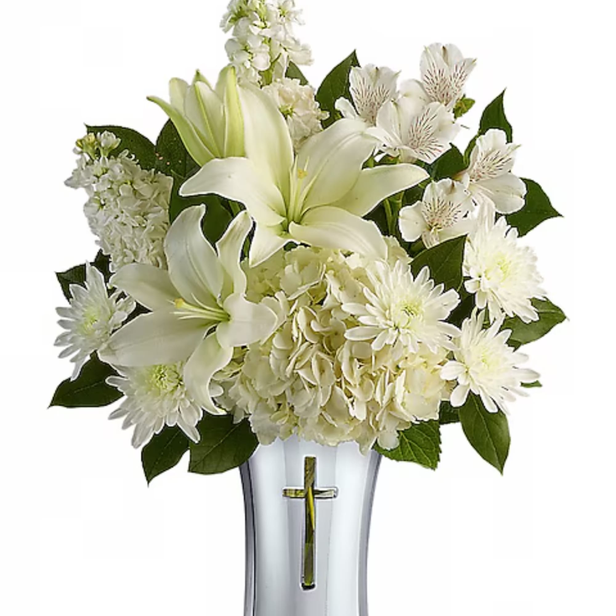 White lilies and daisies arranged in a clear vase with a cross emblem