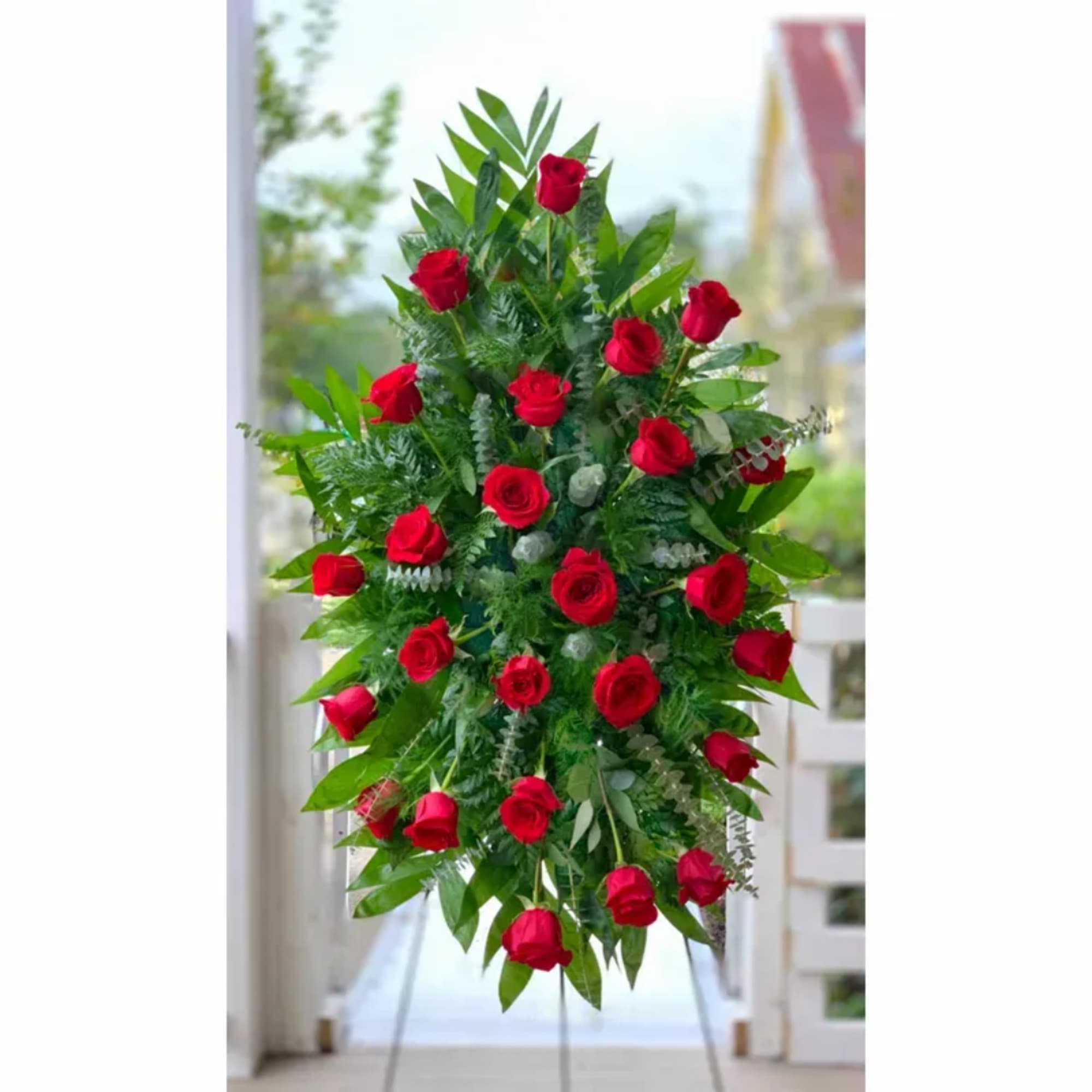 Standing spray of red roses with greenery