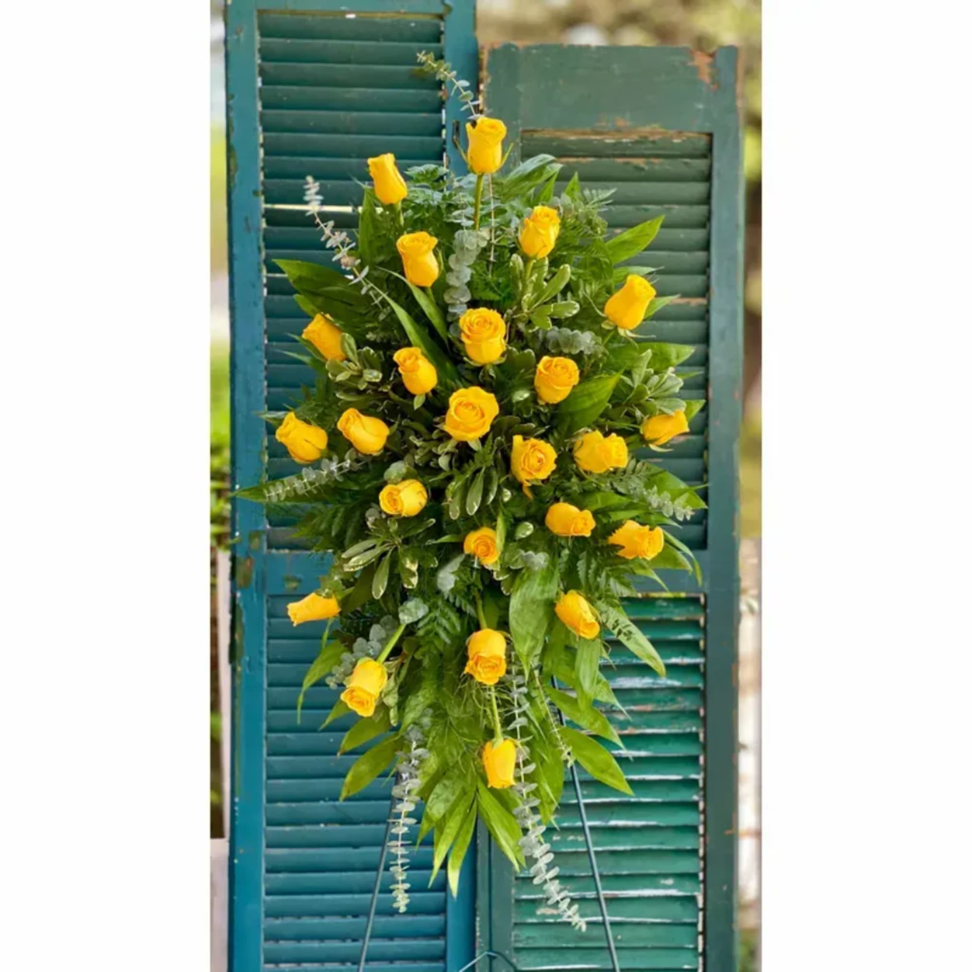 Tall yellow rose arrangement on a teal shutter backdrop