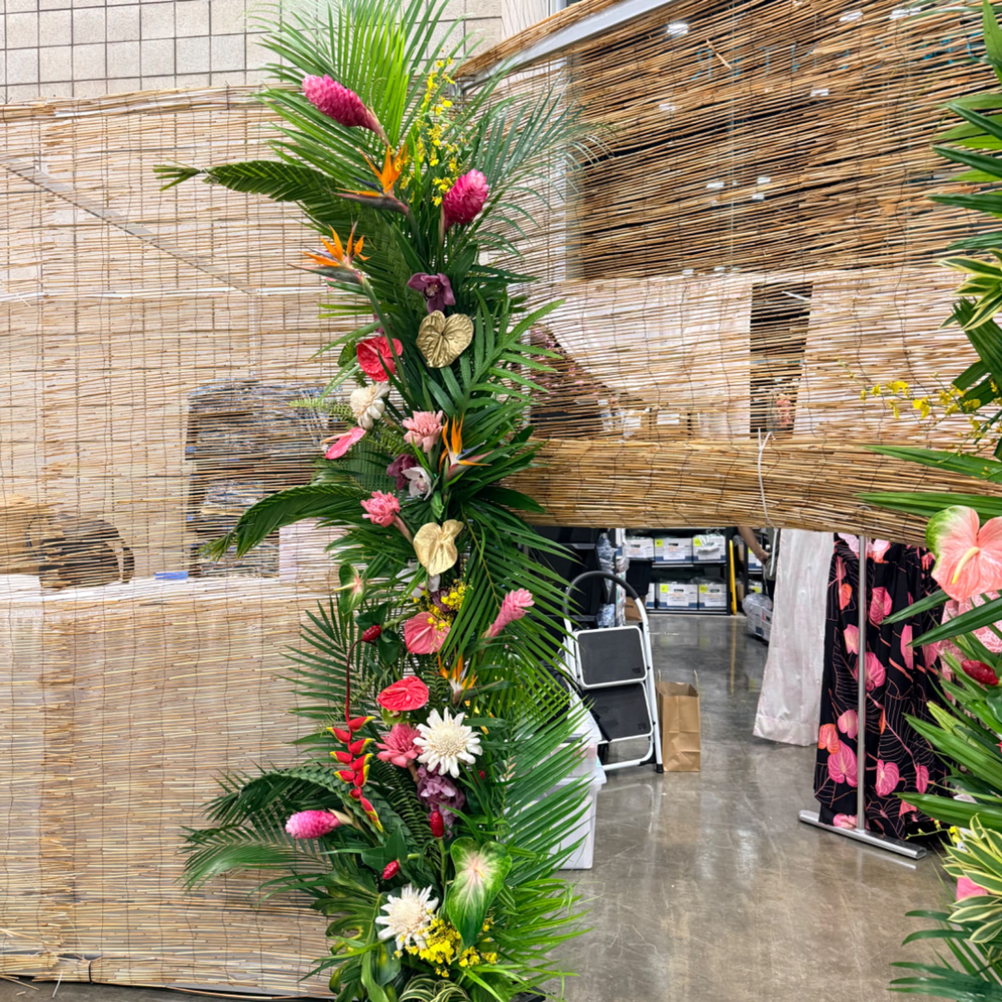 Tall tropical floral arrangement with pink and white blooms